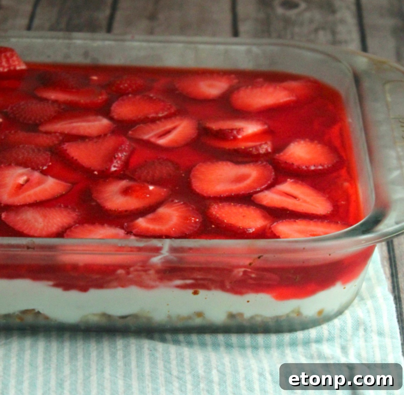 Individual serving of Strawberry Pretzel Salad in a glass dish, showing the layers and texture clearly.