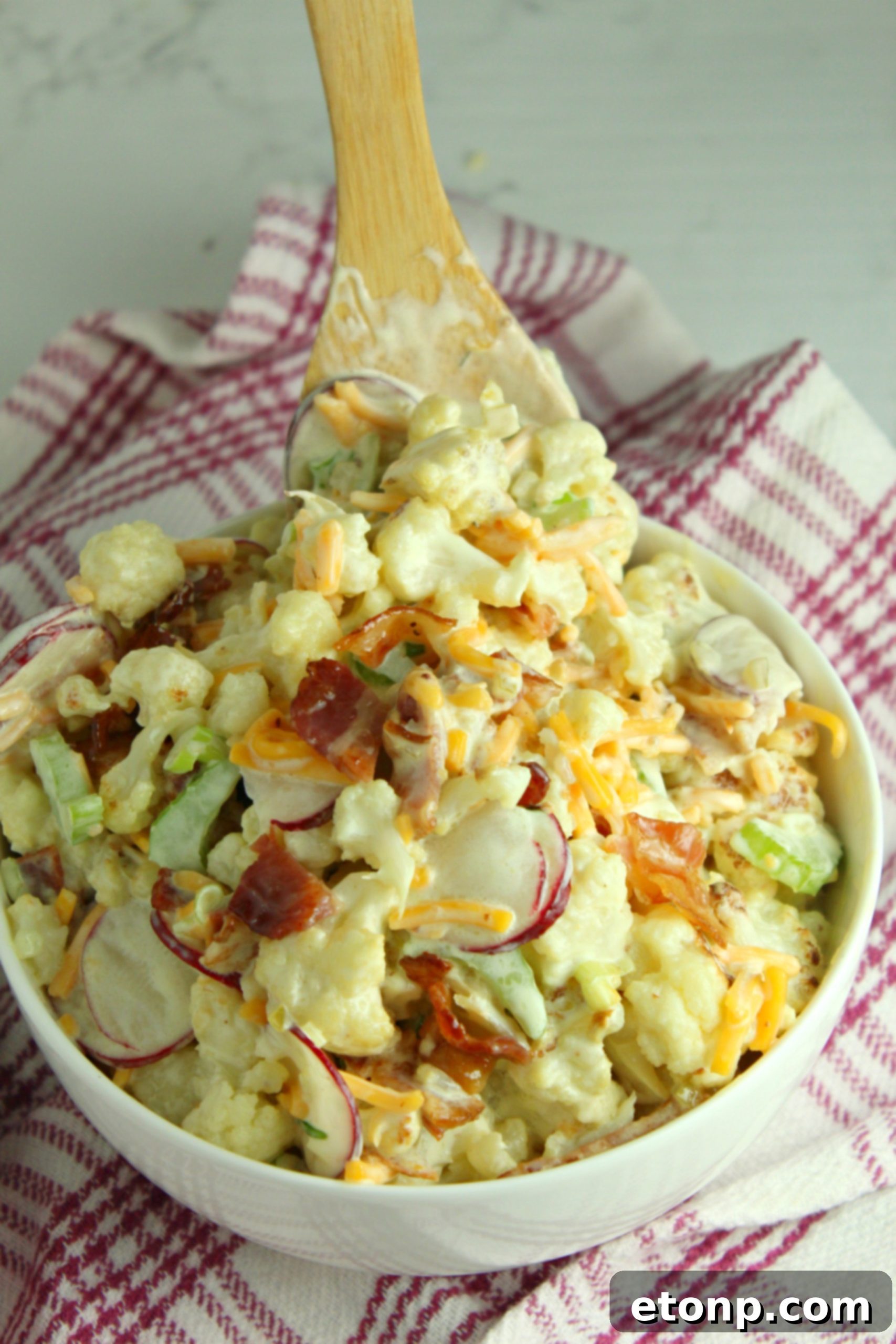 Close-up of loaded cauliflower salad with green onions