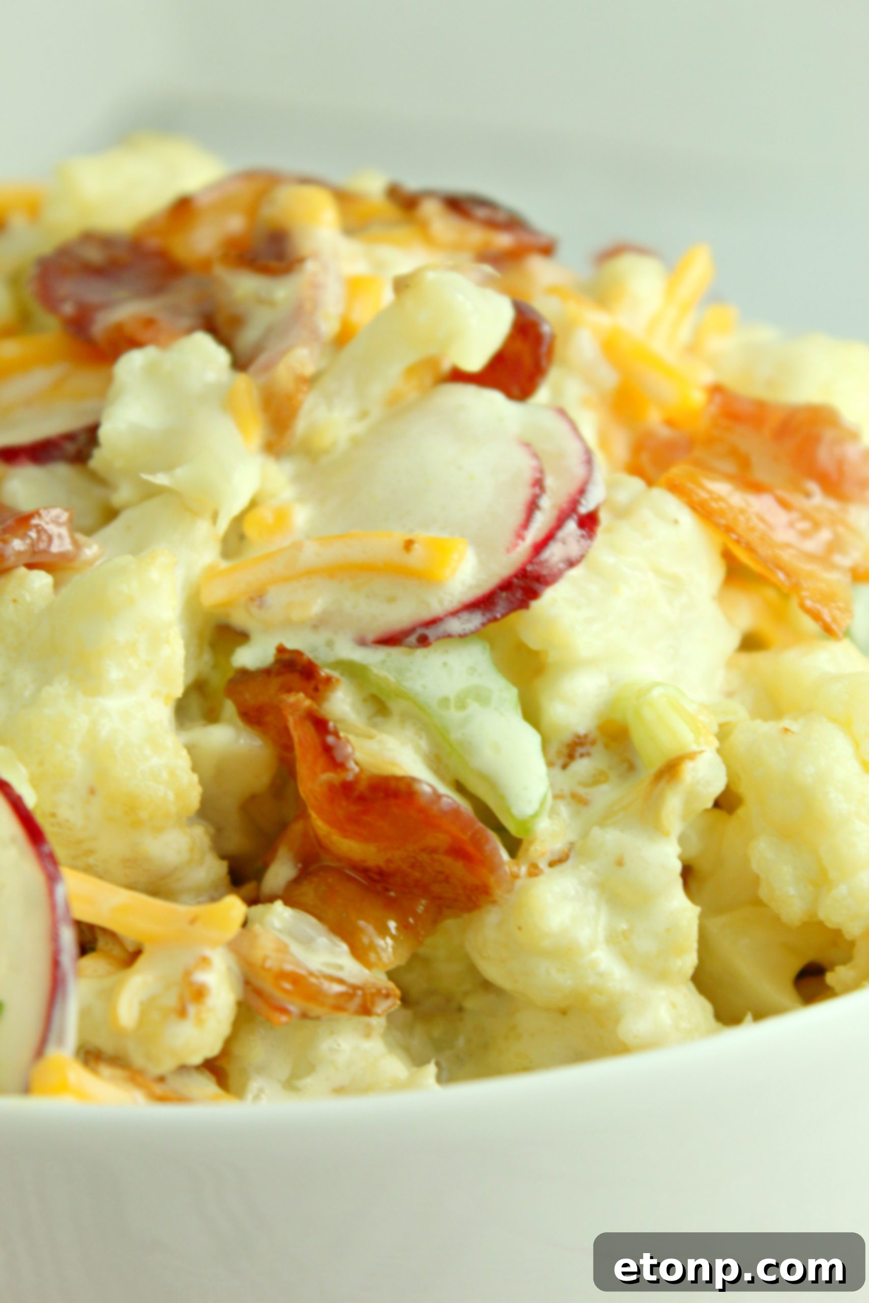 Large bowl of Loaded Cauliflower Salad, ideal for gatherings
