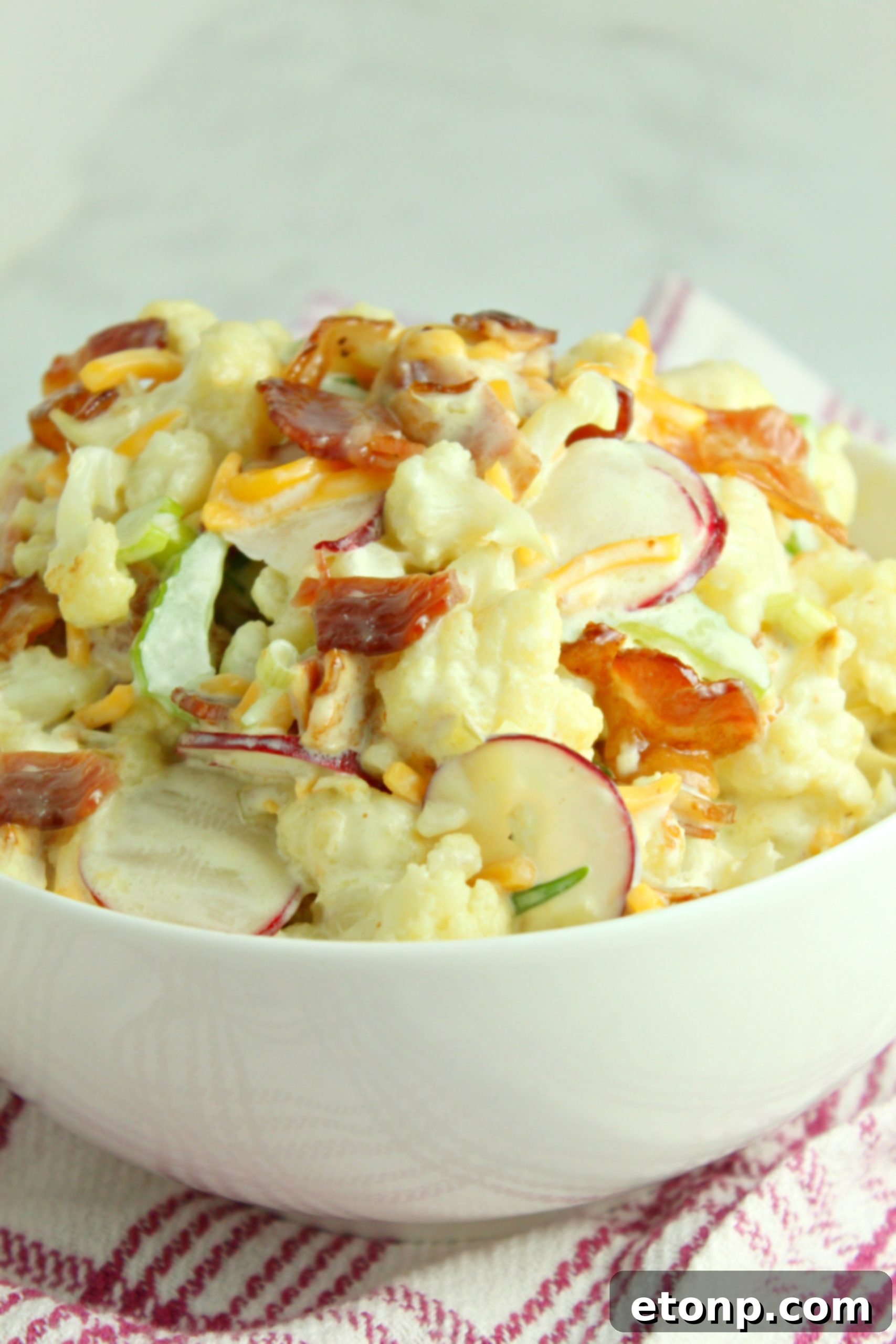 Finished Loaded Cauliflower Salad in a serving dish