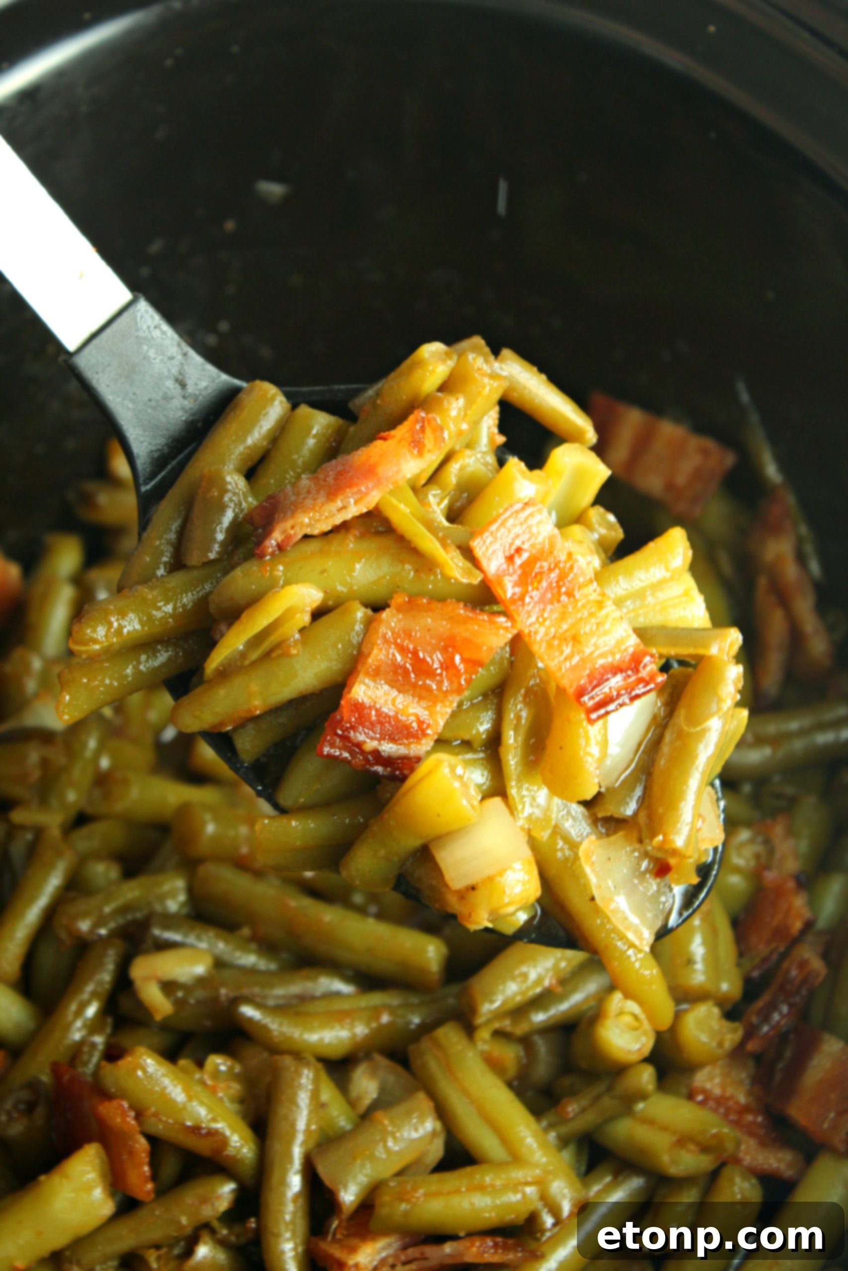 Slow Cooker Buttery Bacon Green Beans ready to be served, glistening with butter and bacon