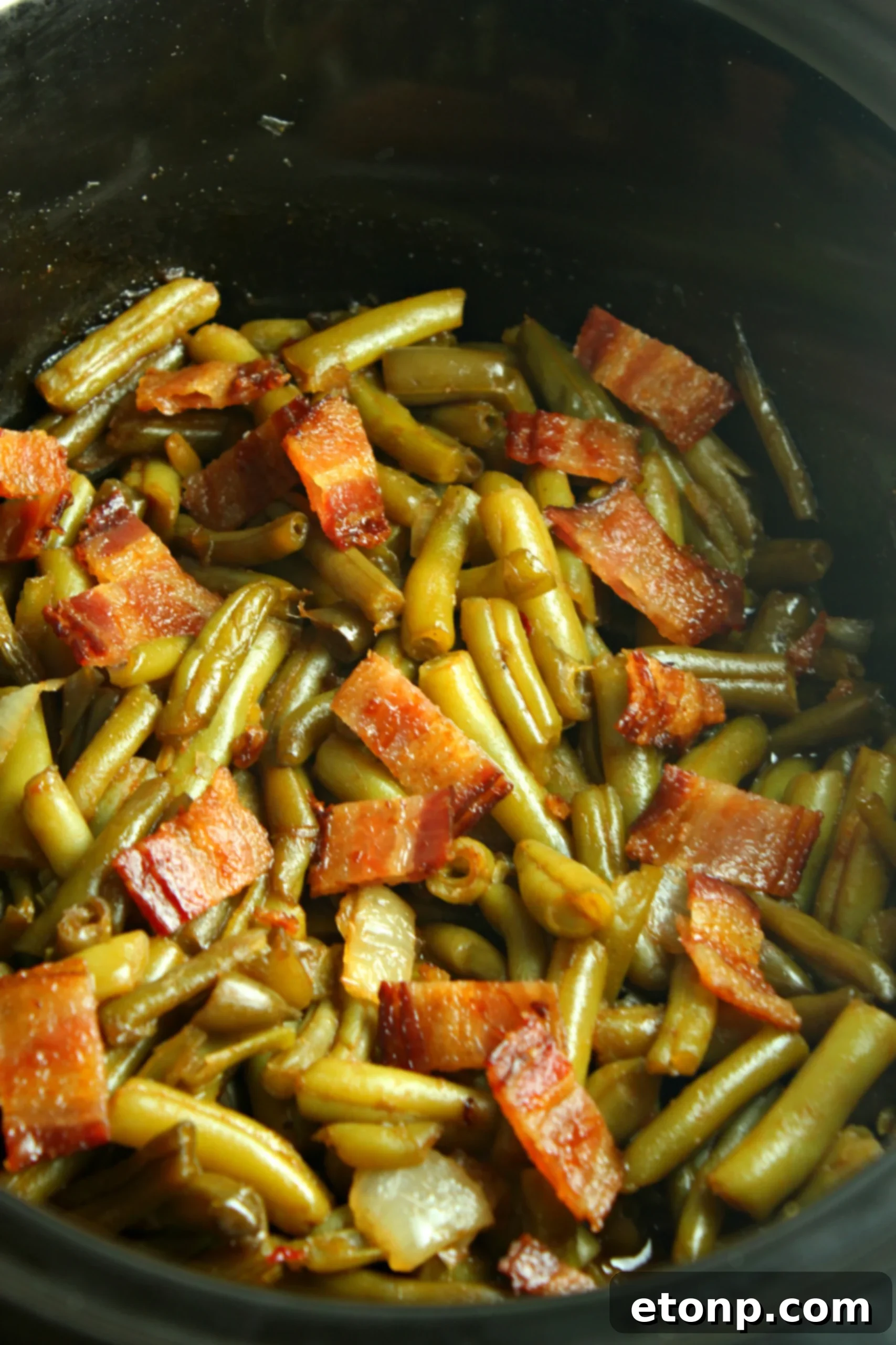 A closer shot of the Slow Cooker Buttery Bacon Green Beans, highlighting the texture and topping