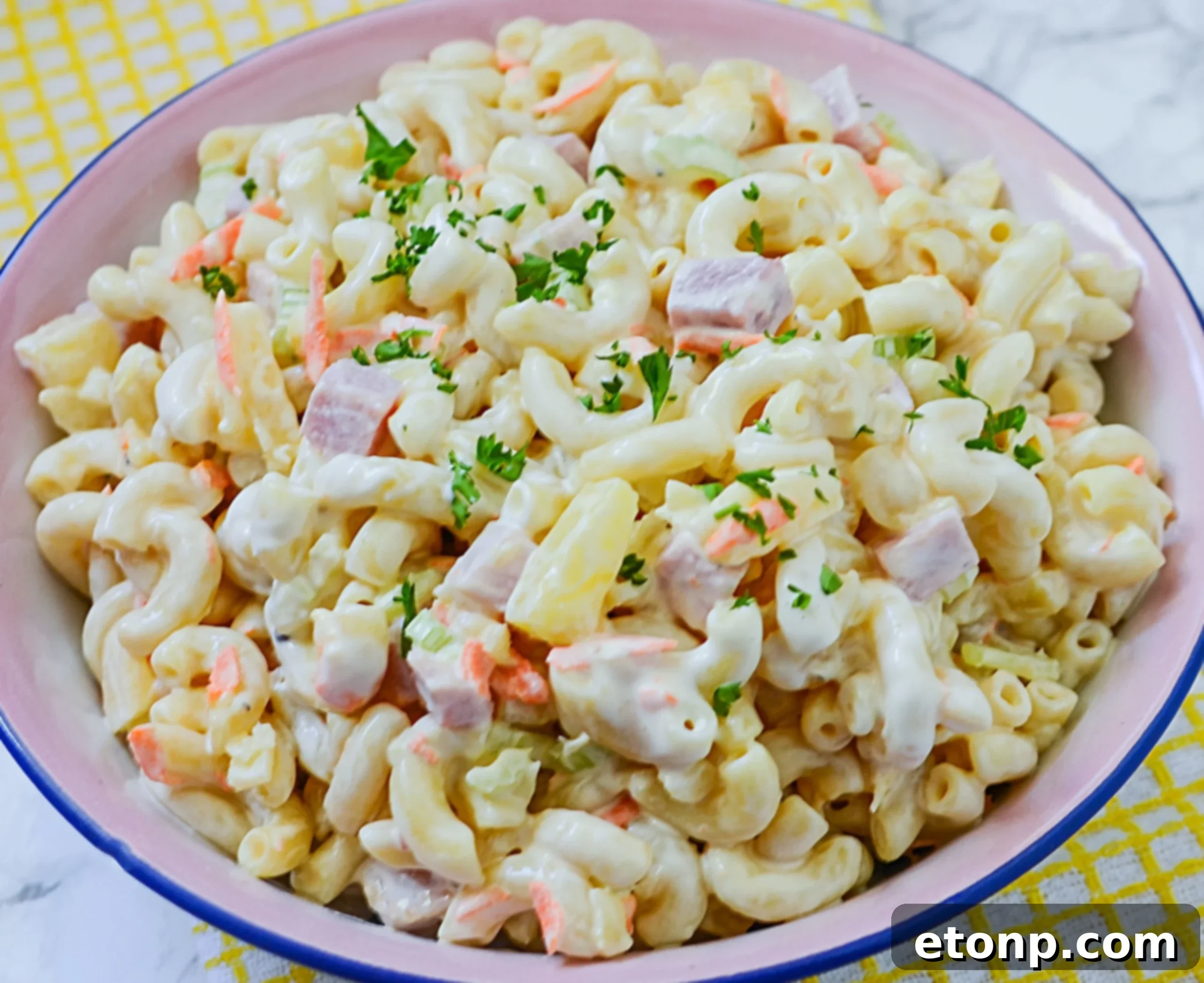 Island Macaroni Bliss 2 Hawaiian Macaroni Salad served in a large bowl, garnished with green onions.