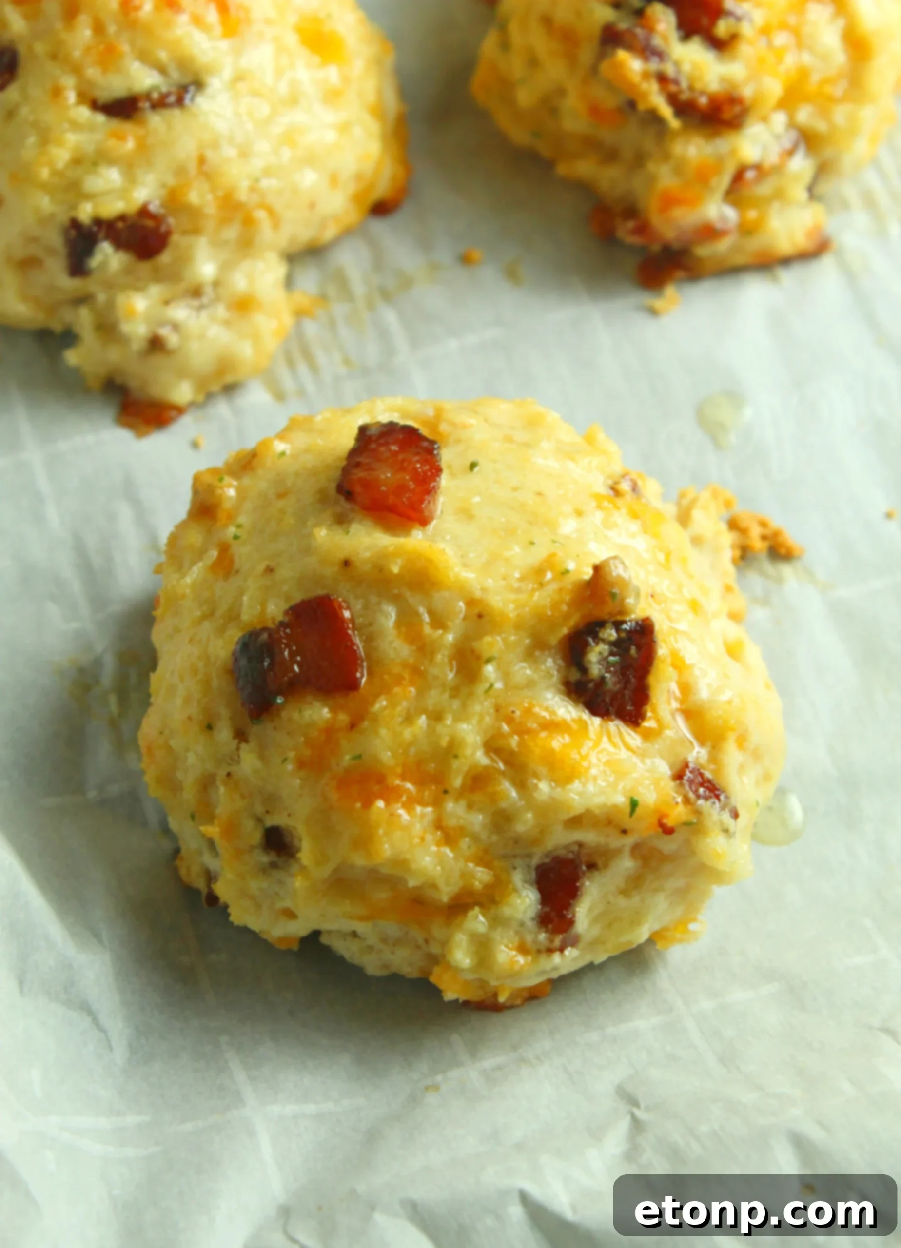 A close-up shot of the interior of a Cheesy Bacon Garlic Biscuit, showing the fluffy texture and melted cheese.