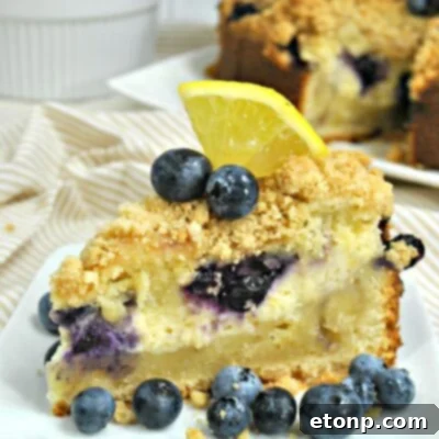 Finished Blueberry Cream Cheese Coffee Cake with streusel topping and cream cheese visible.