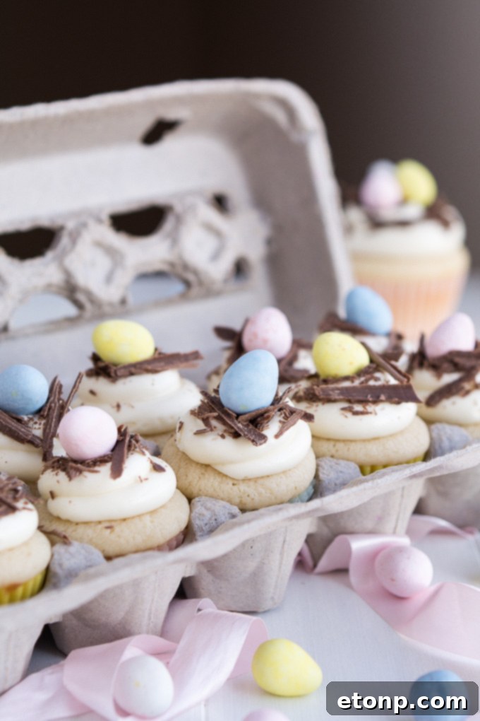 Close-up of pastel Easter cupcakes decorated with mini eggs and sprinkles