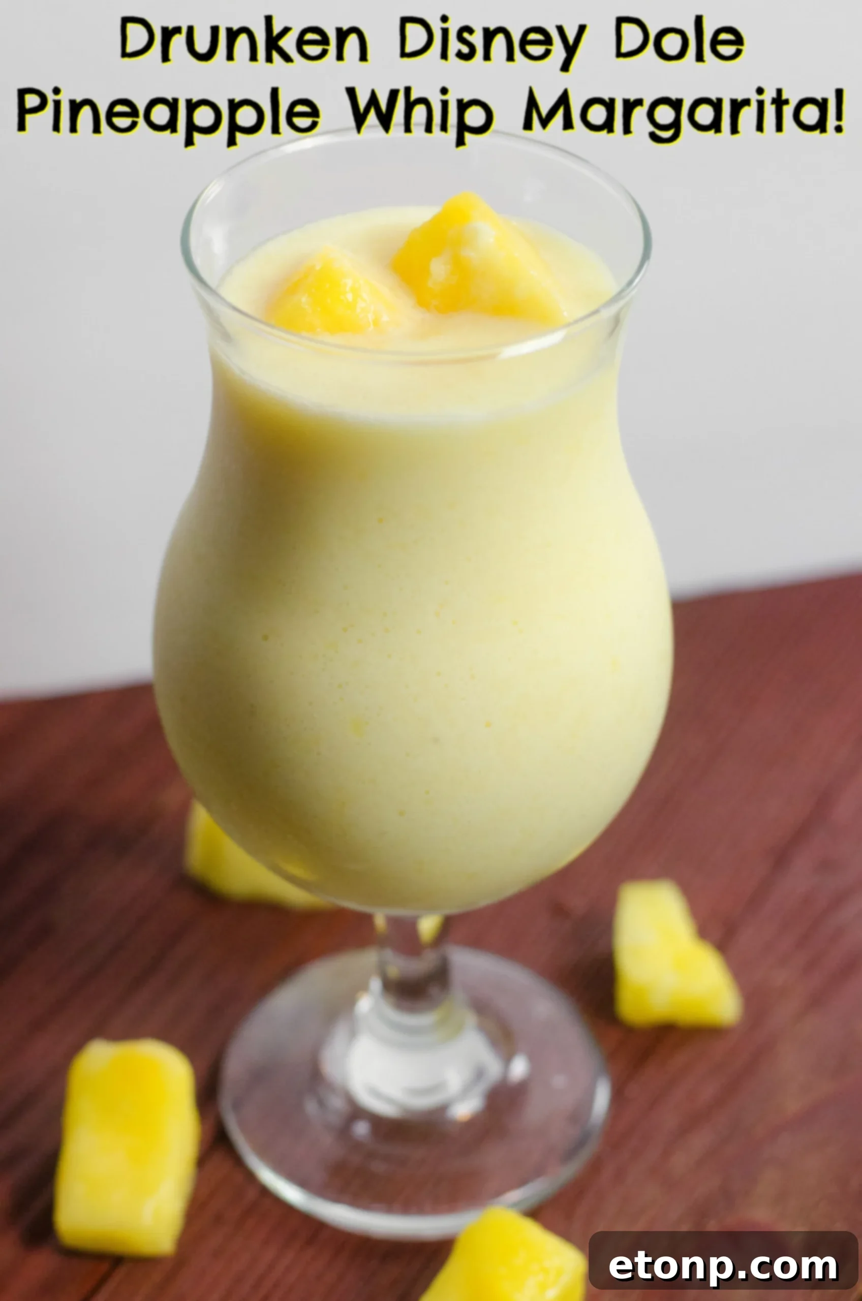 A refreshing Drunken Disney Dole Pineapple Whip Margarita, garnished with a pineapple wedge and cherry.