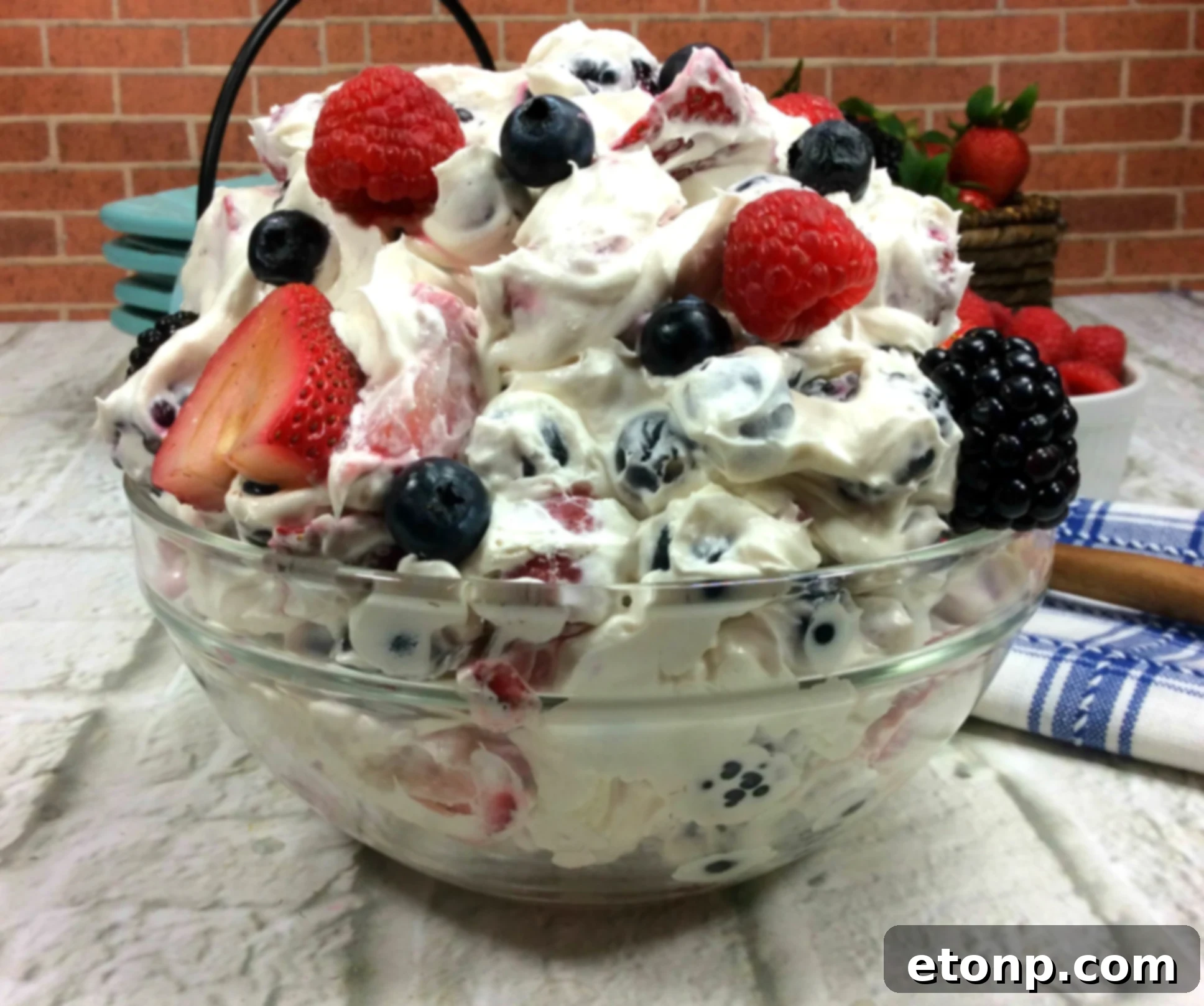An overhead shot of Cheesecake Summer Berry Salad with a vibrant mix of berries beautifully arranged within the creamy cheesecake base.