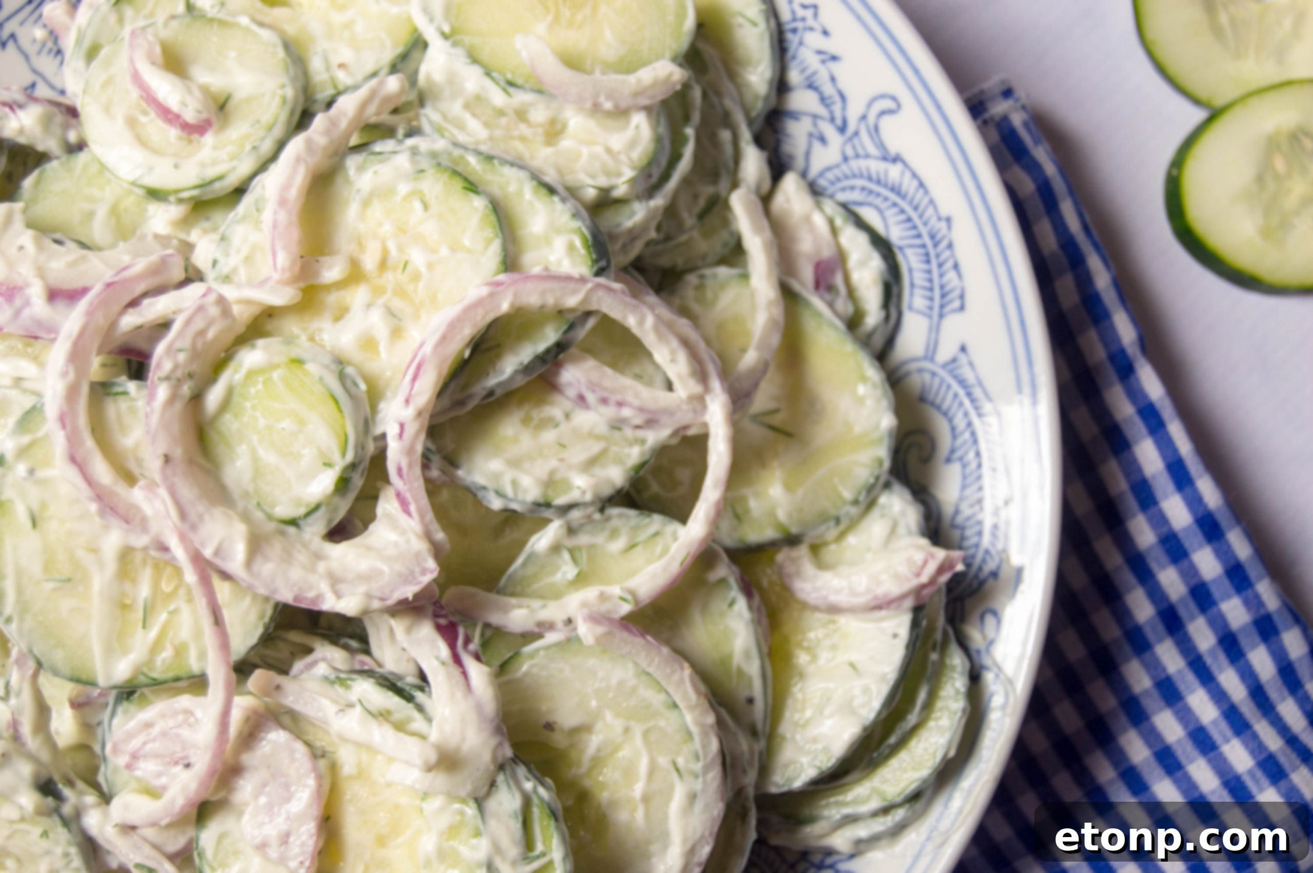 Serving creamy cucumber salad onto a plate