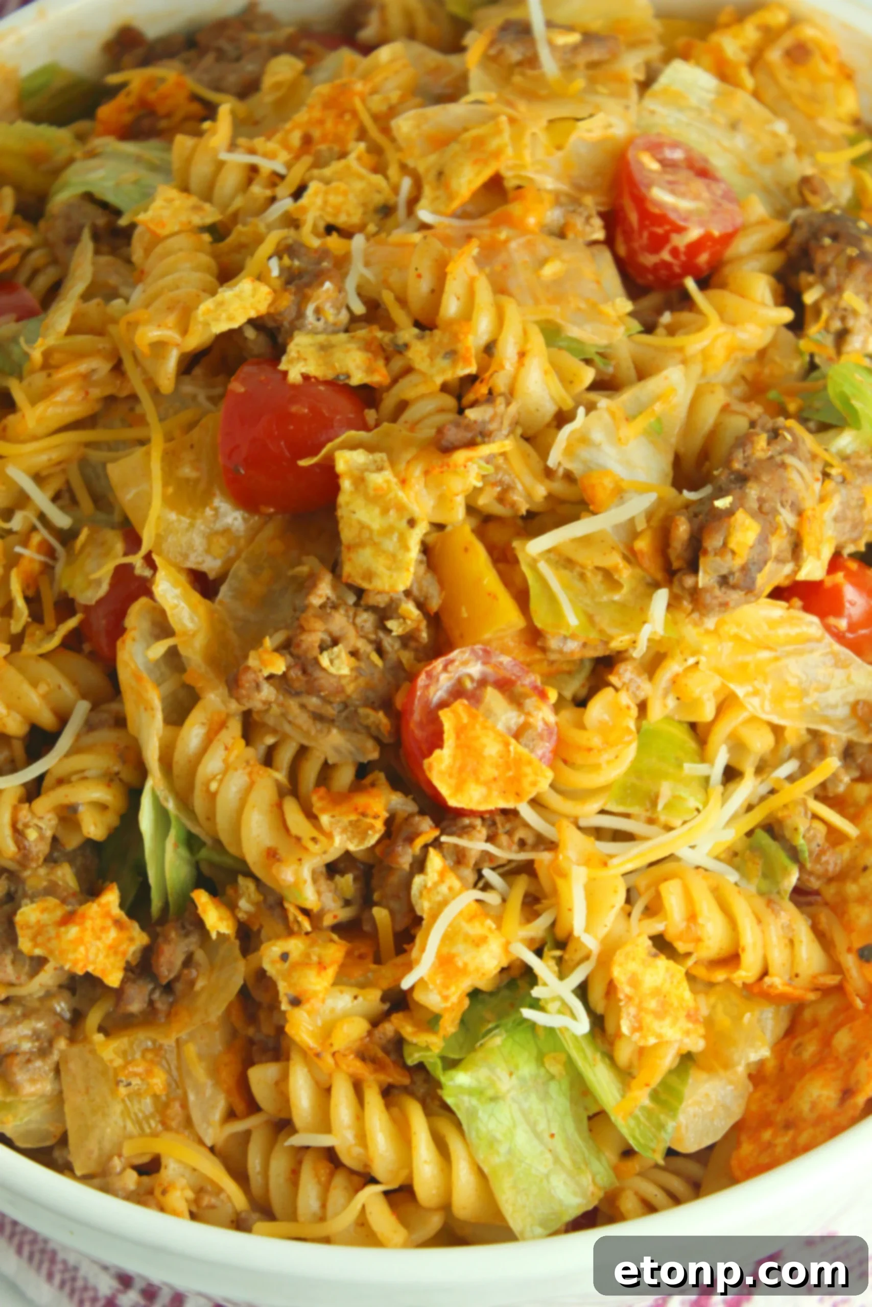 A serving of Doritos Locos Taco Pasta Salad with an emphasis on the crunchy Doritos pieces mixed in, illustrating the unique texture.