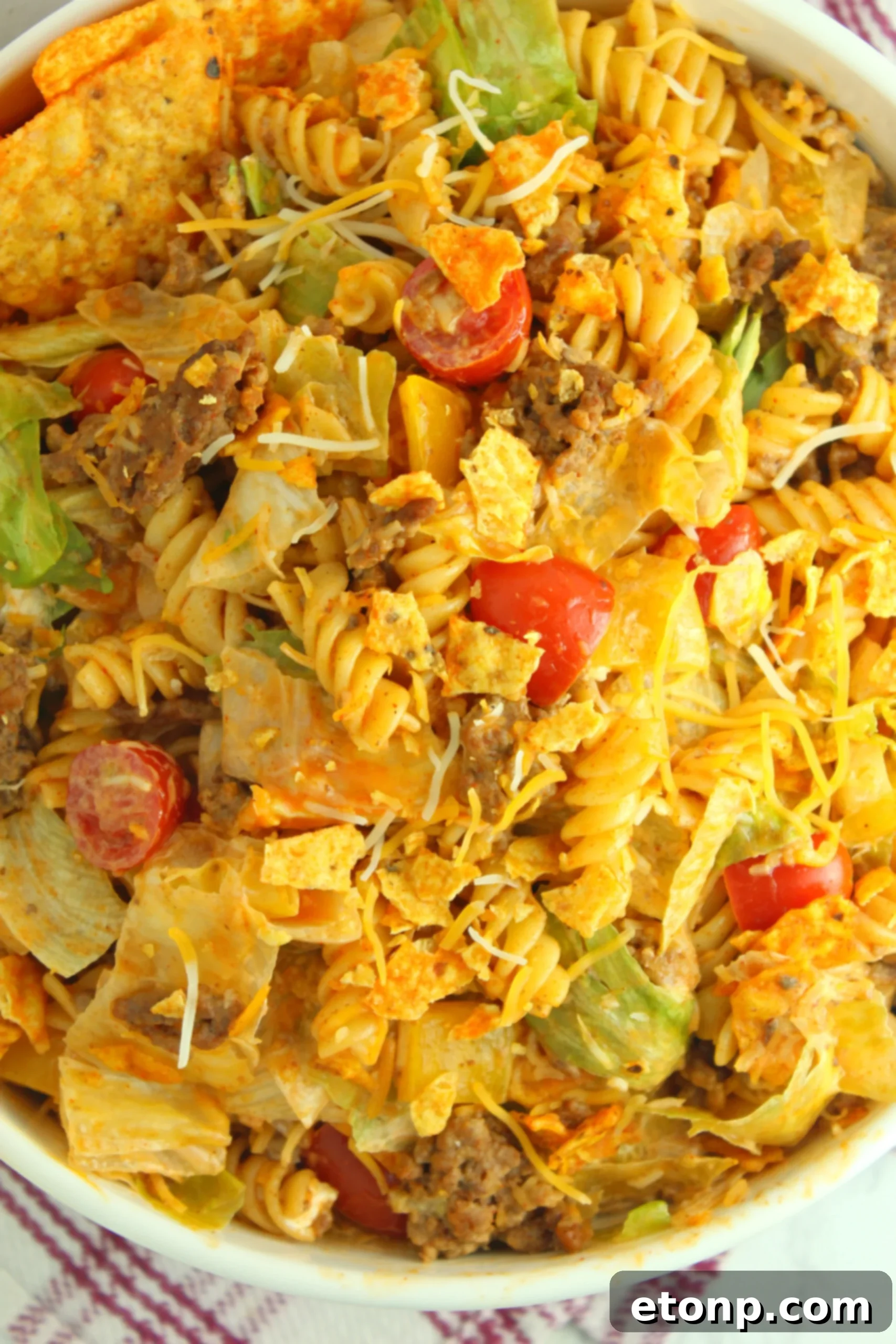 The finished Doritos Locos Taco Pasta Salad, garnished and ready to serve, inviting readers to make it a weekly favorite.