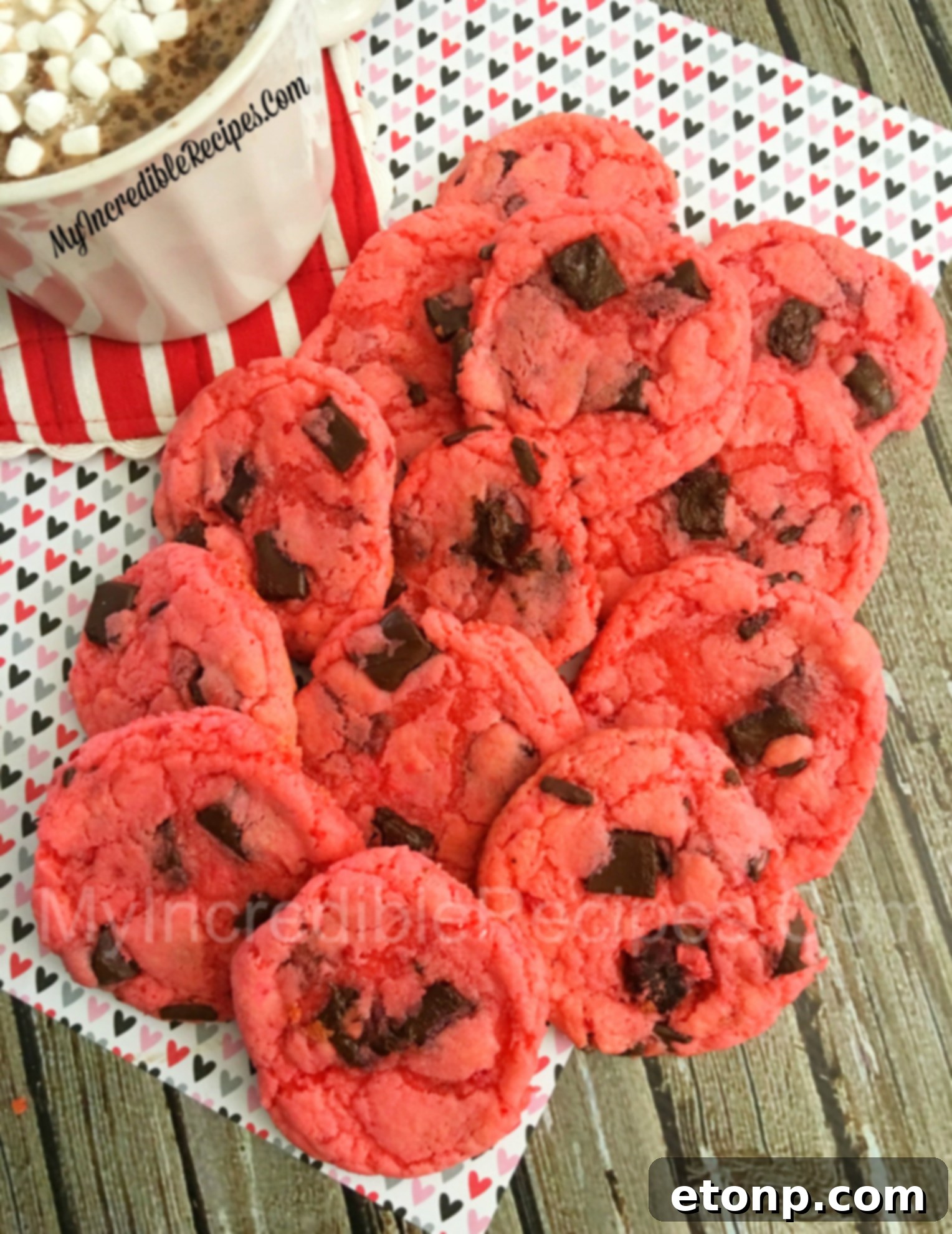 Freshly baked strawberry chocolate chunk cookies cooling on a rack