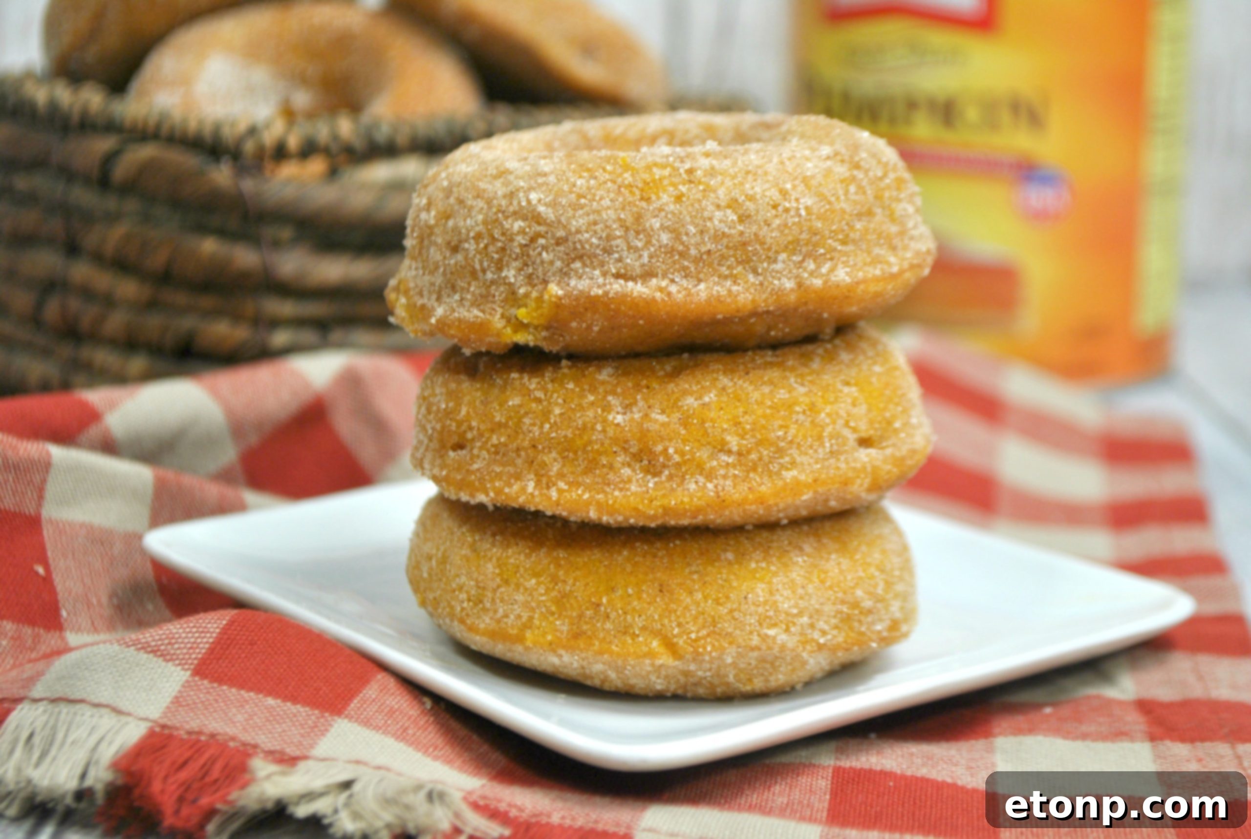 Close-up of a stack of pumpkin spice donuts with a sugar coating