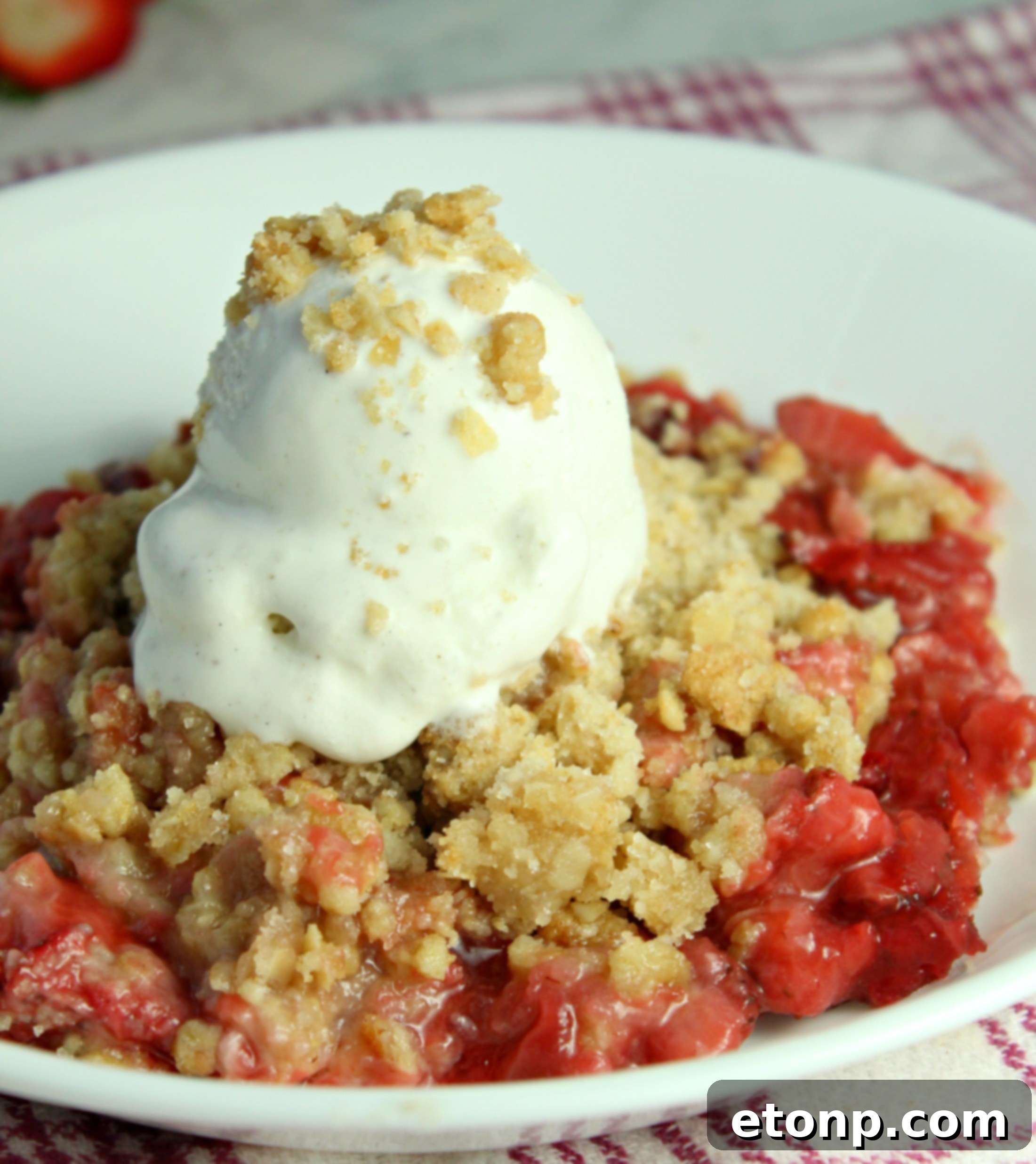Fresh Strawberry Crisp with a scoop of vanilla ice cream