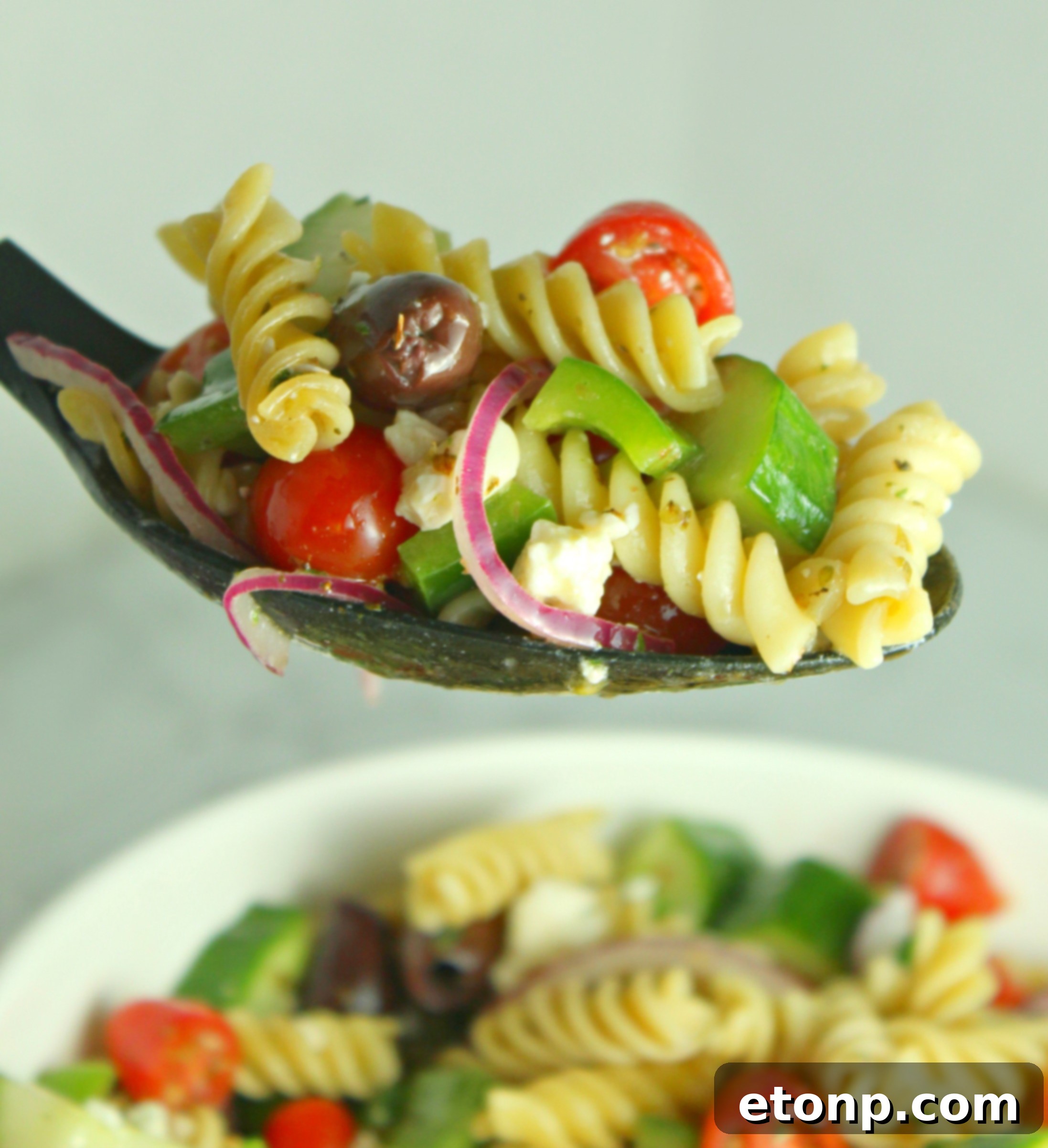 The finished Greek Pasta Salad in a large bowl, ready to be served.