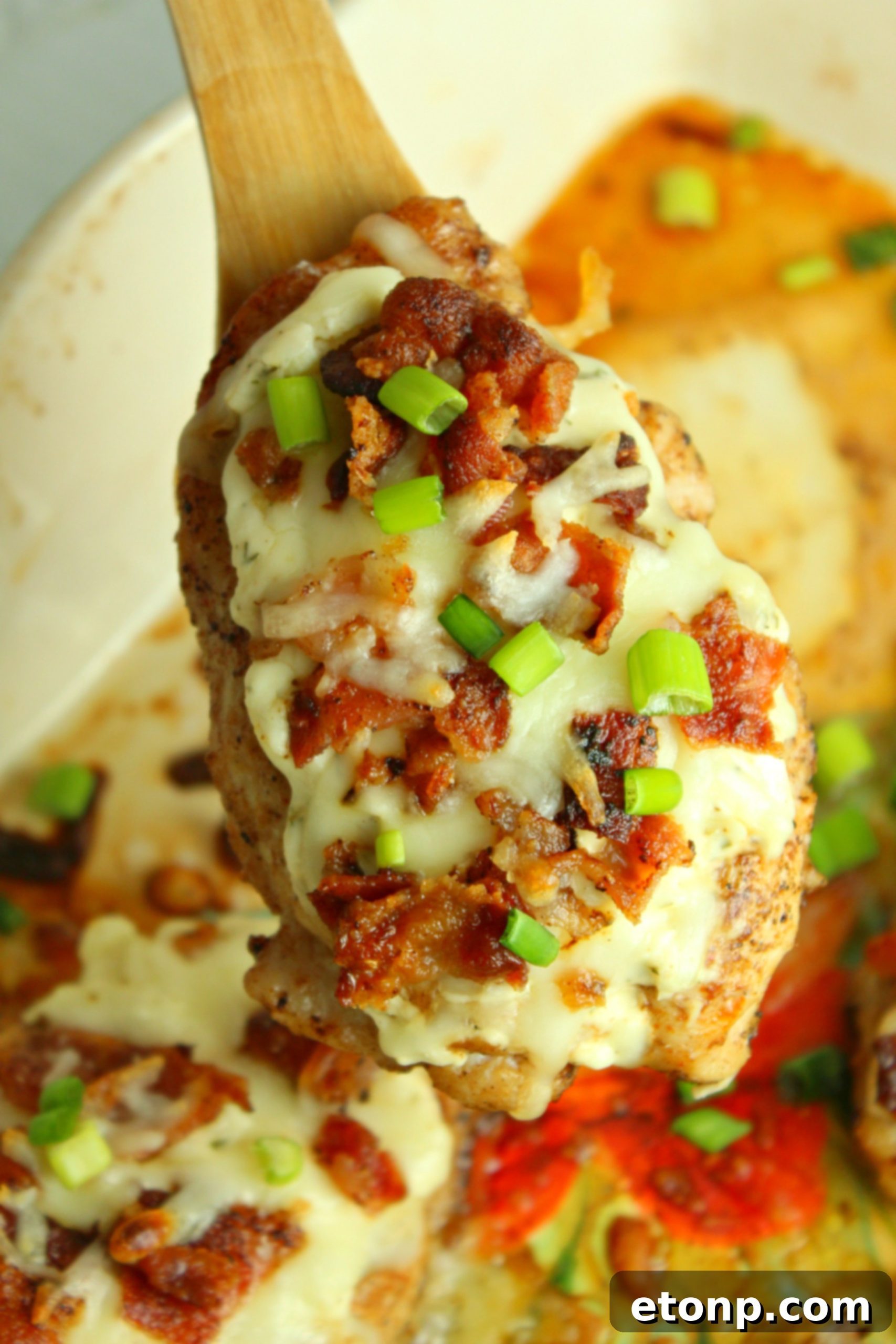Overhead view of a perfectly cooked Smothered Crack Chicken dish, generously garnished with fresh herbs
