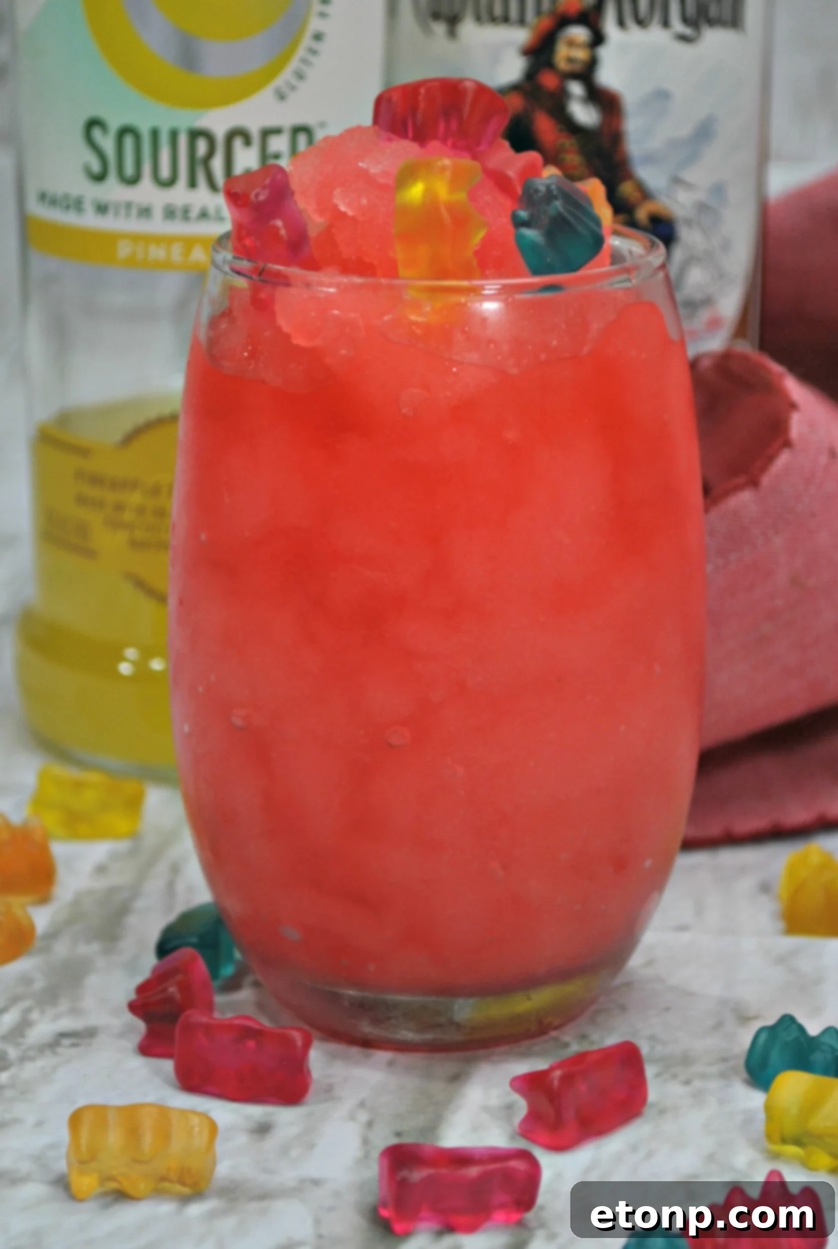 Drunken Gummy Bear Cocktail with a straw and more gummy bears, ready to be enjoyed