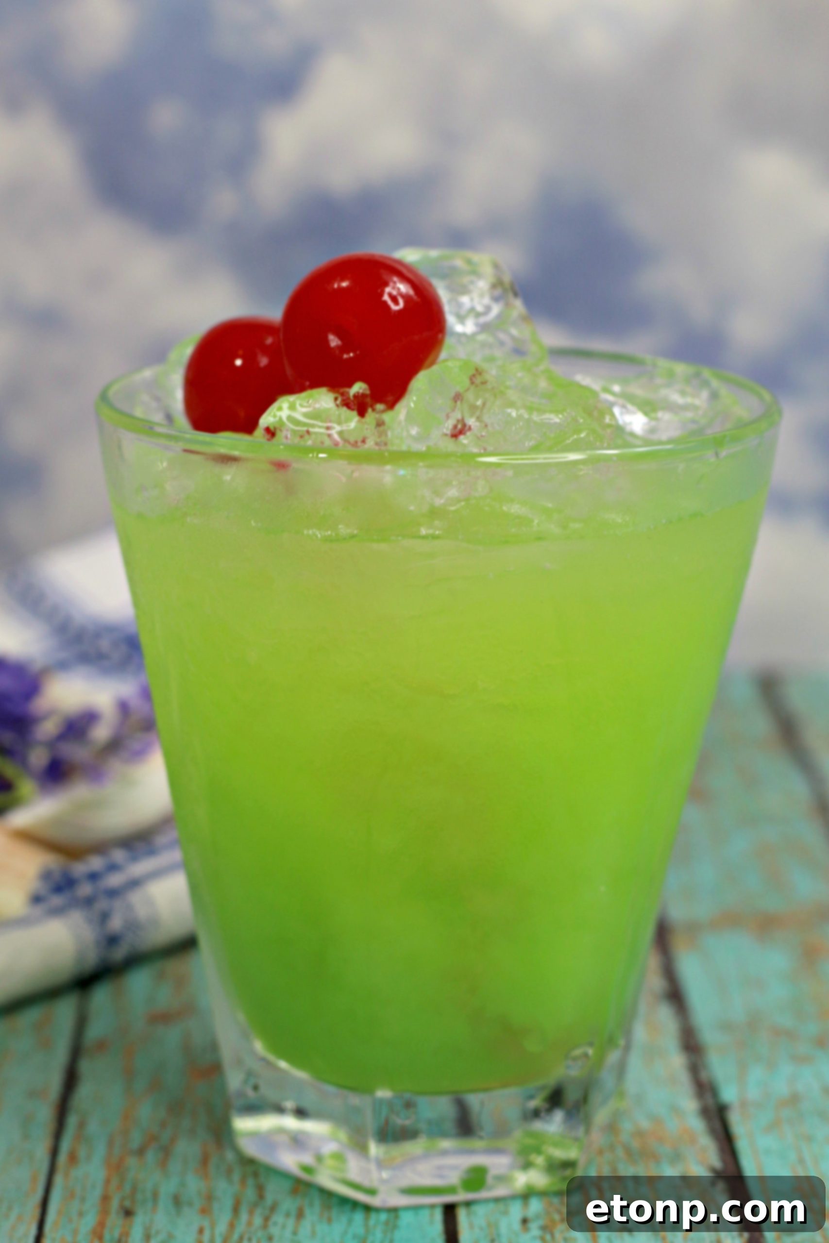 Emerald Iguana Elixir 4 Four Green Iguana Cocktails arranged on a tray, ready for serving at a party, showing off their vibrant color and elegant presentation.