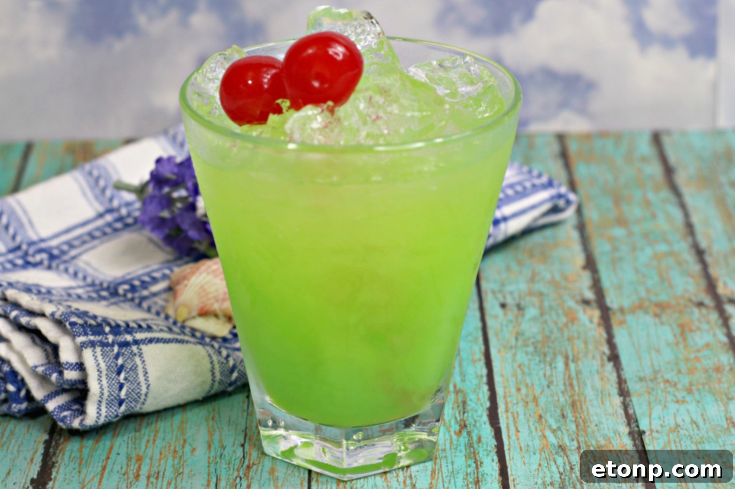 Emerald Iguana Elixir 5 A vibrant selection of tropical cocktails, including the Green Iguana, presented elegantly on a serving tray, perfect for a party.