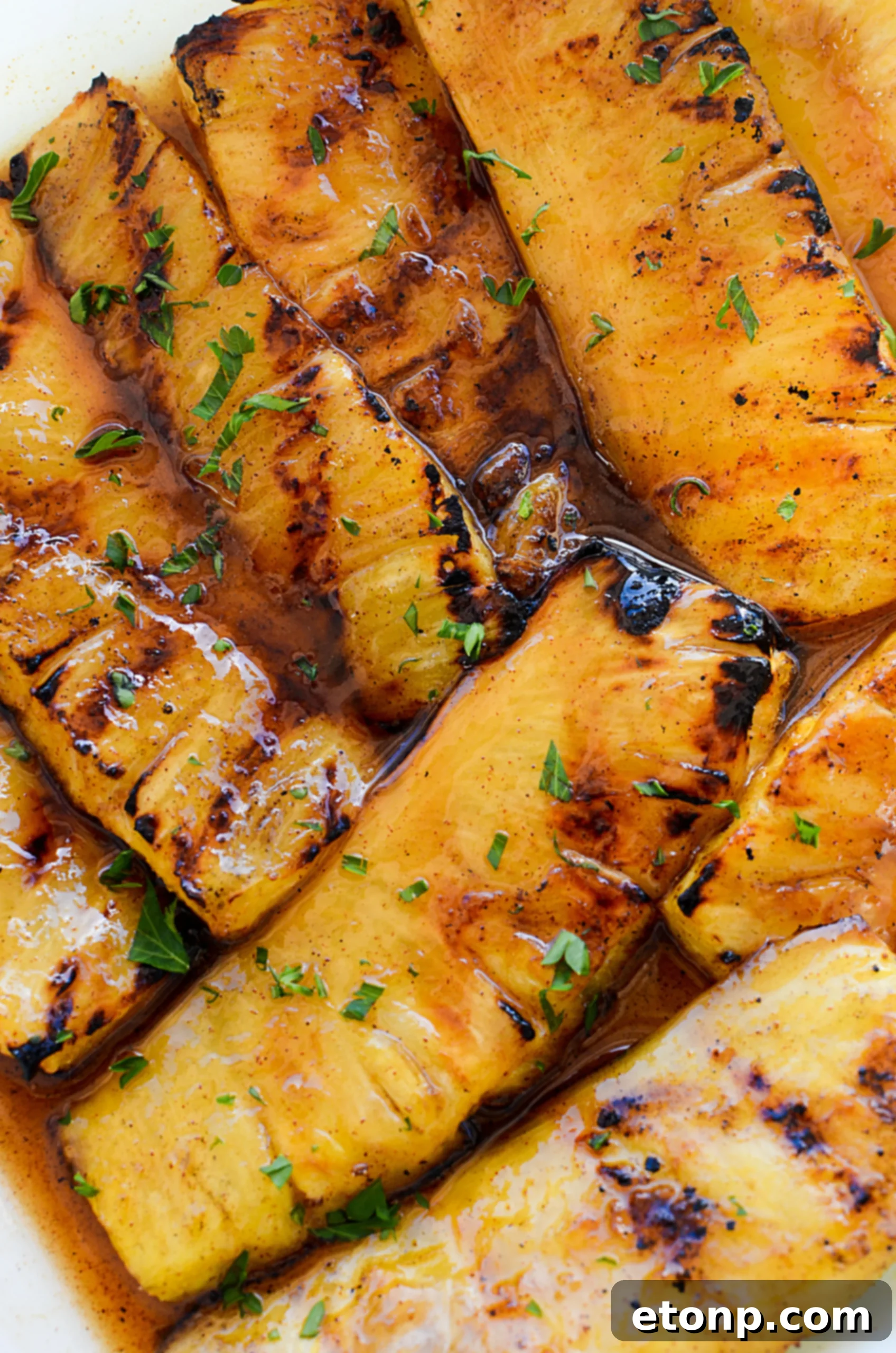Juicy grilled pineapple spears coated in cinnamon sugar, ready to be served