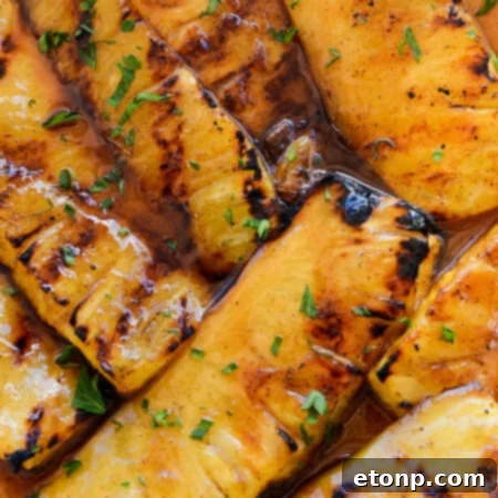 A small, appealing image of grilled pineapple as part of a recipe card layout.