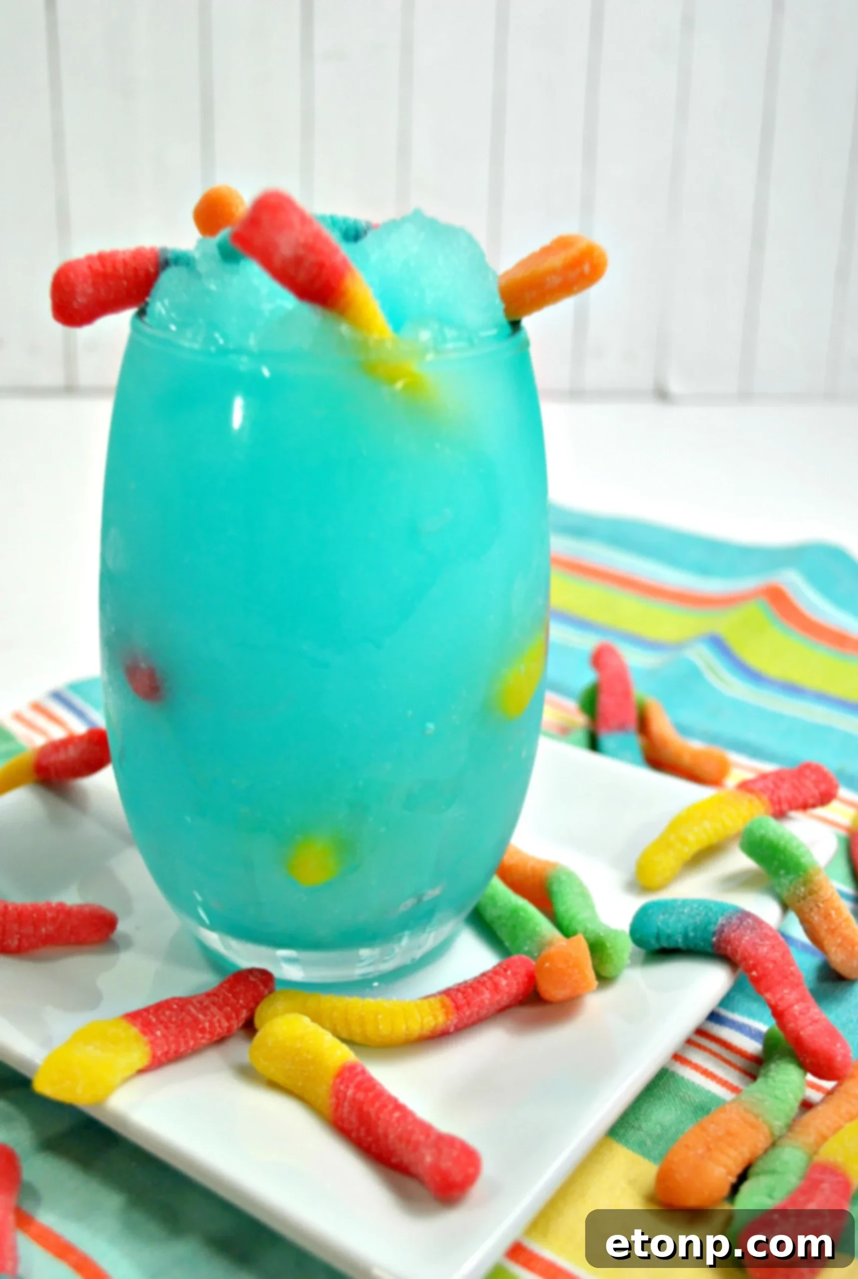 Close-up of the icy, blue Drunken Sour Gummy Worm Cocktail