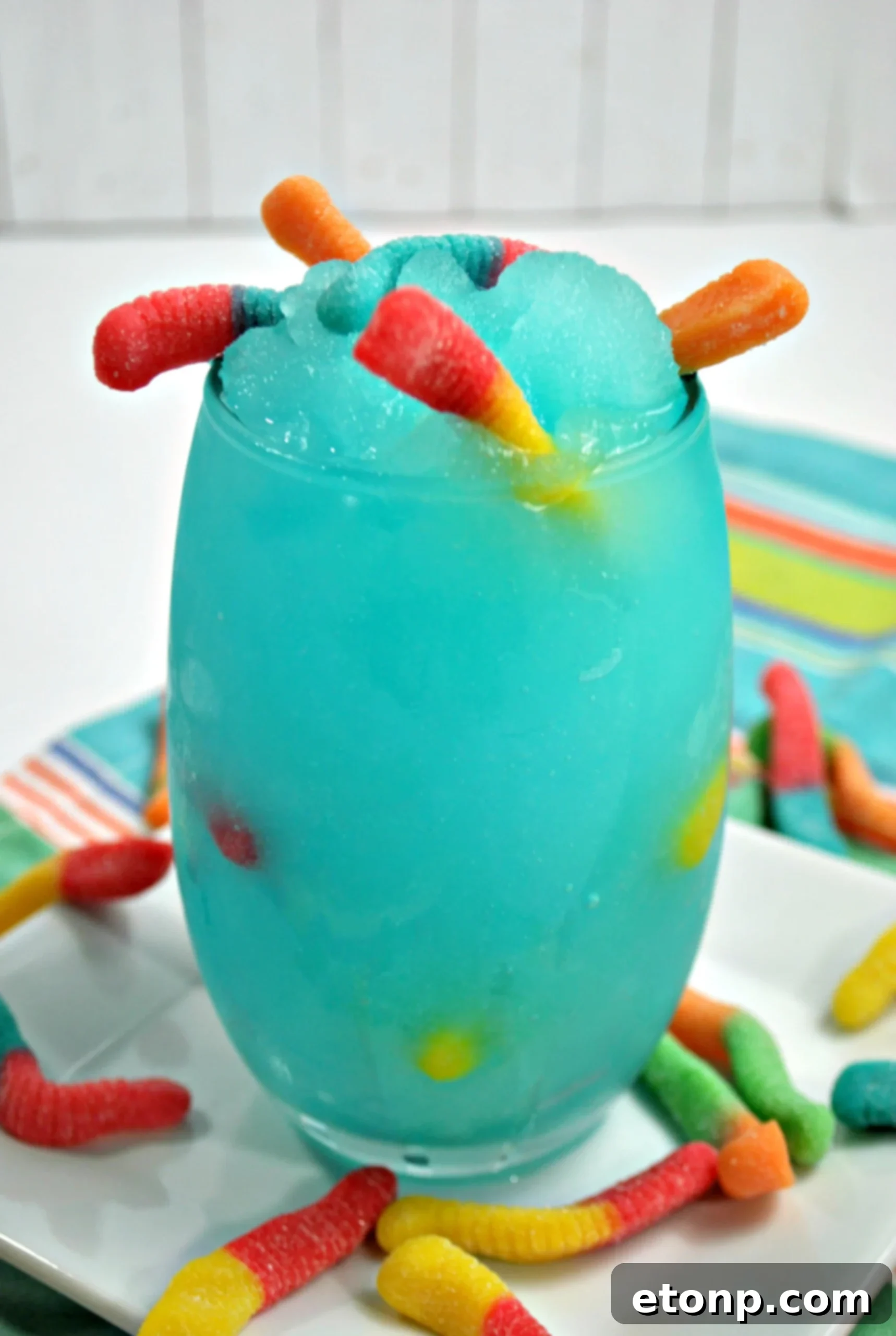Top-down view of the Drunken Sour Gummy Worm Cocktail with numerous gummy worms