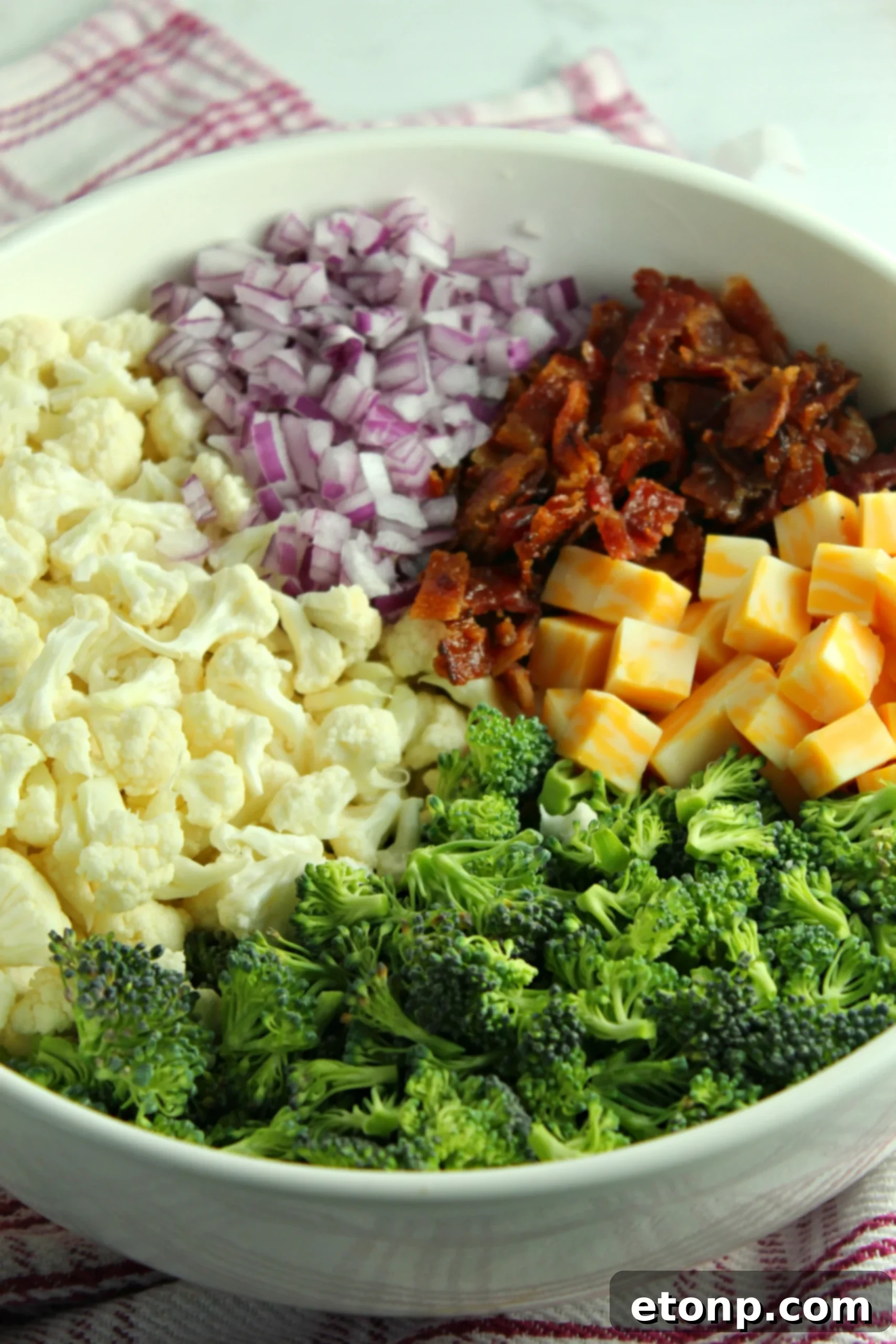Rich and Flavorful Low Carb Broccoli Cauliflower Salad 3 Overhead shot of a large bowl filled with Loaded Broccoli Cauliflower Salad, showing the fresh vegetables, golden bacon, and cheese cubes.