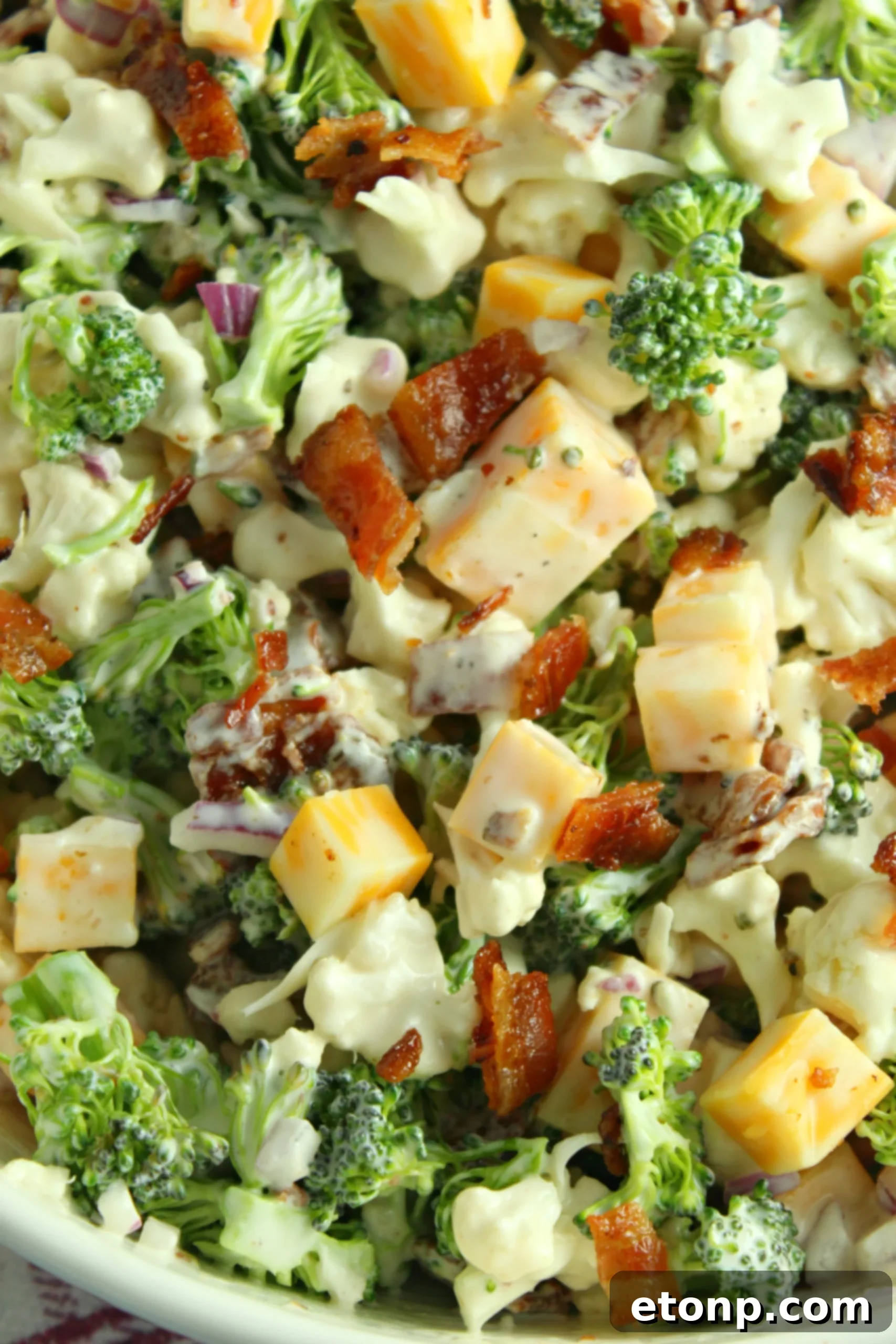 Rich and Flavorful Low Carb Broccoli Cauliflower Salad 5 A close-up of the Loaded Broccoli Cauliflower Salad in a serving bowl, showcasing the colorful ingredients and appealing texture.