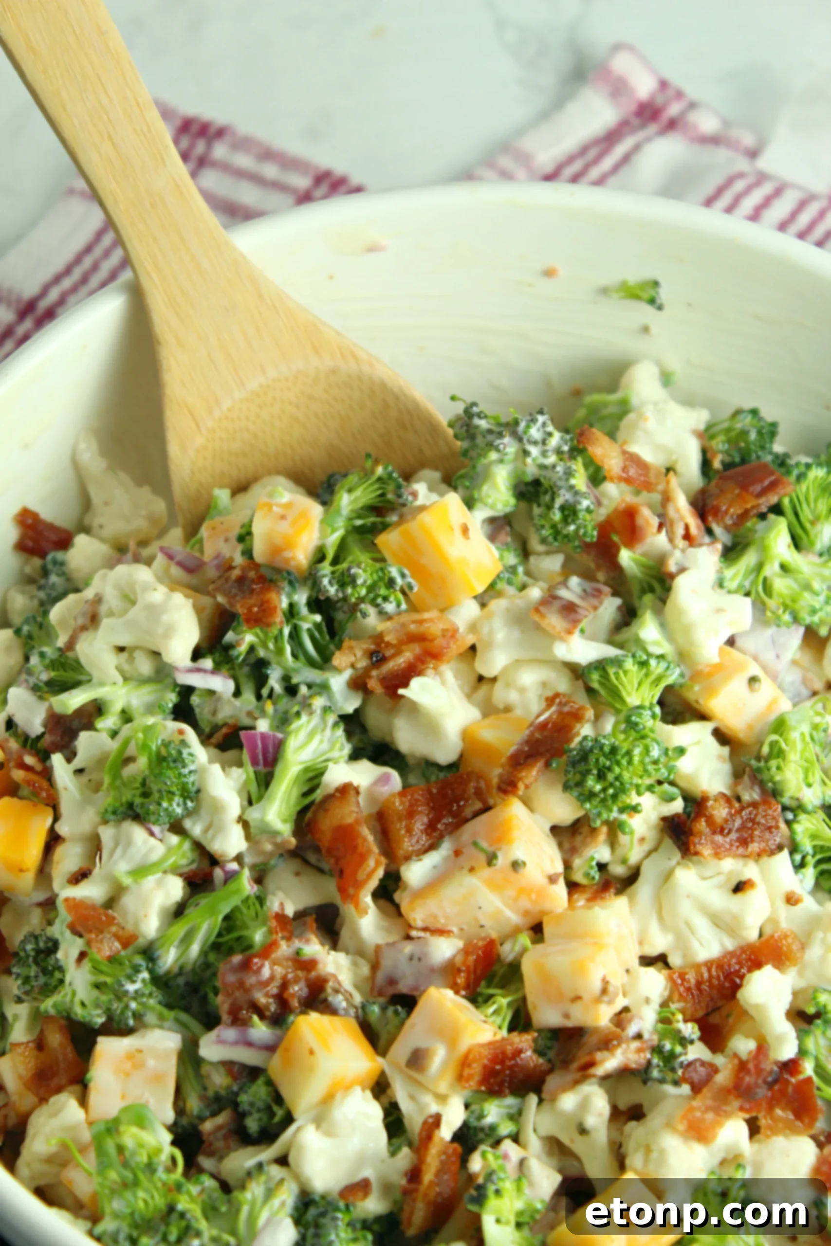 Rich and Flavorful Low Carb Broccoli Cauliflower Salad 8 Individual ingredients for the salad dressing – Greek yogurt, mayonnaise, honey, red wine vinegar, sugar, salt, and pepper – in small bowls.