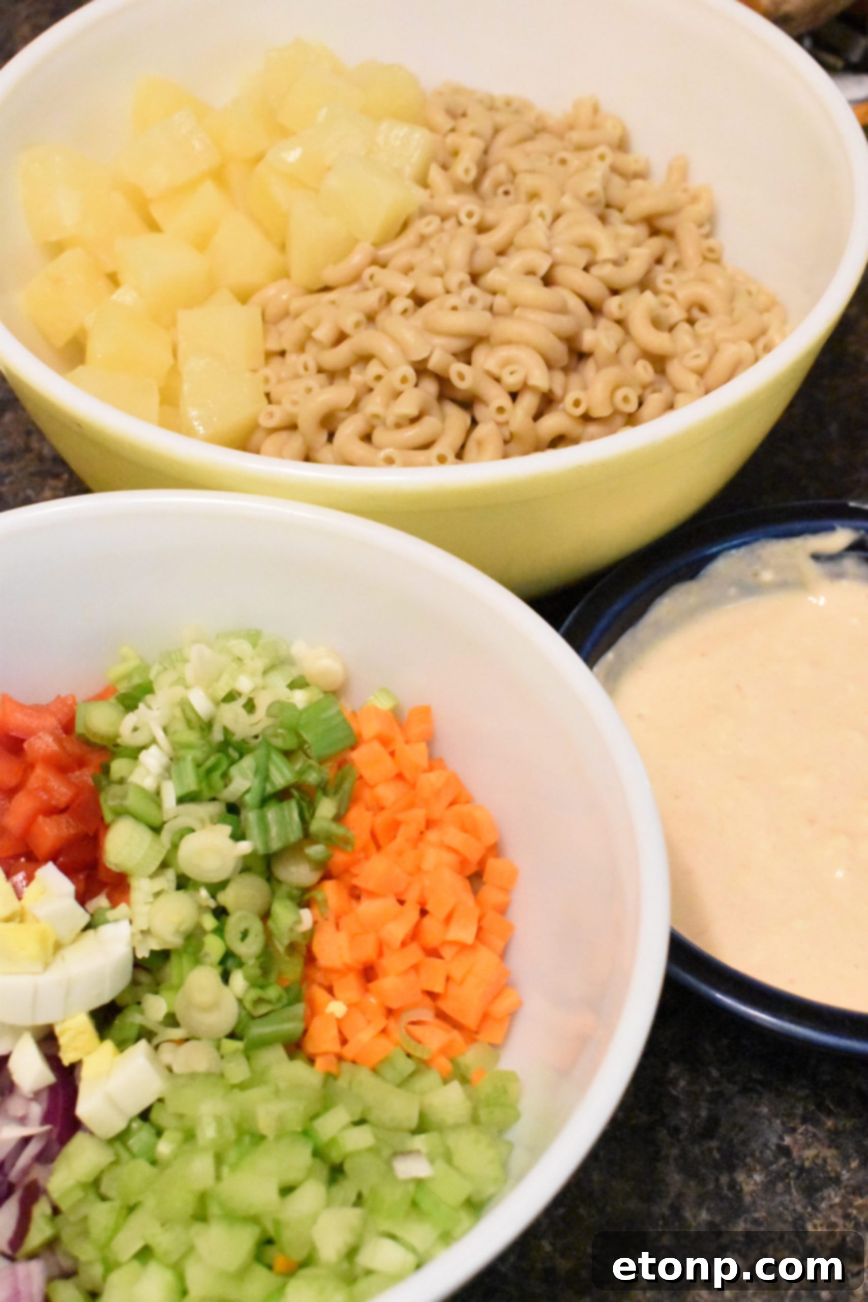 Paradise Macaroni Medley 3 Close-up of Tropical Macaroni Salad, showcasing the finely chopped ingredients and creamy dressing, ready to be served.