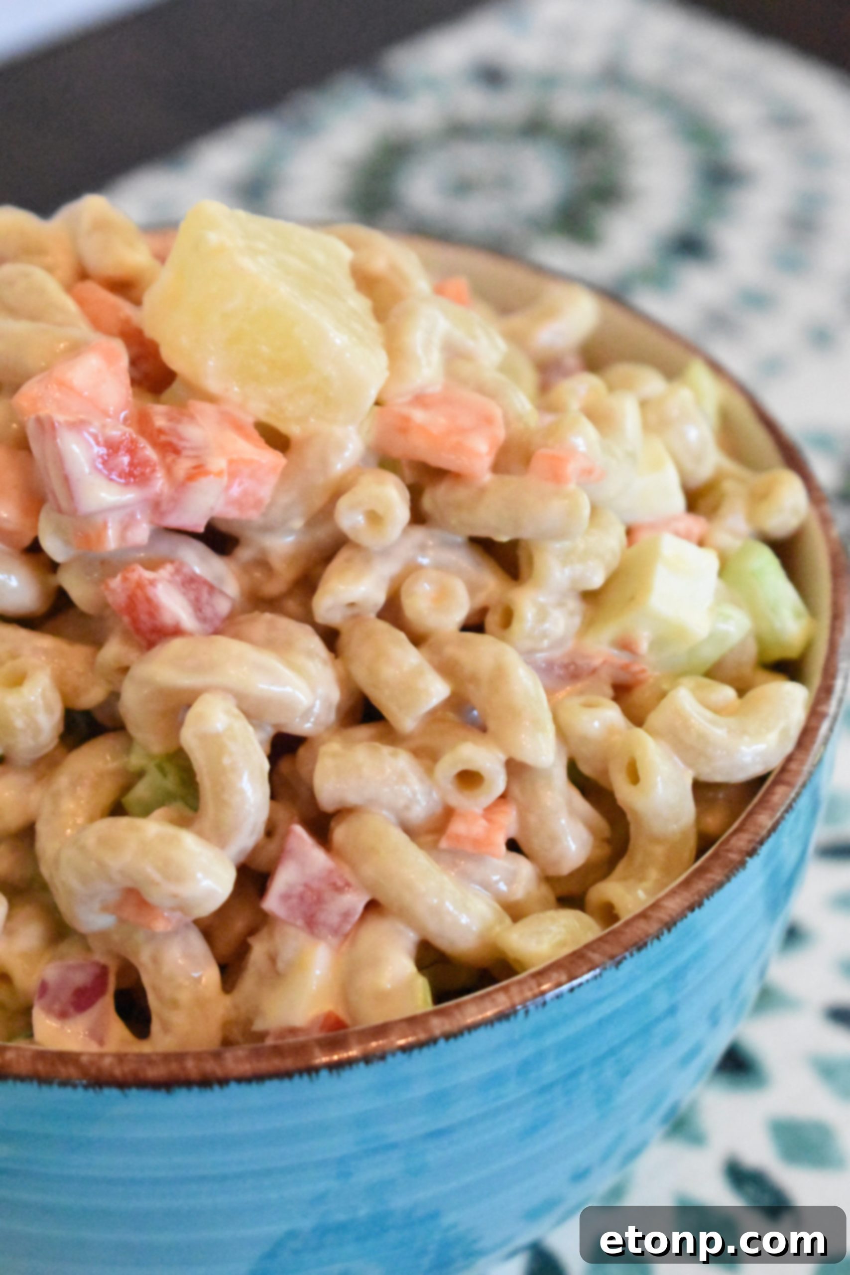 Paradise Macaroni Medley 4 Overhead view of Tropical Macaroni Salad in a large serving bowl, garnished with fresh herbs, ideal for sharing.