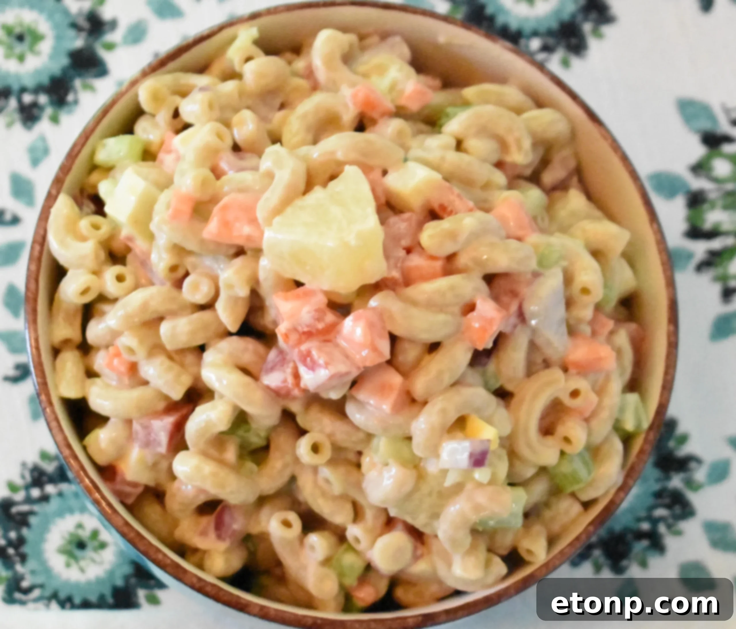 Paradise Macaroni Medley 5 Ingredients for Tropical Macaroni Salad laid out, including cooked macaroni, chopped vegetables, pineapple, and hardboiled eggs.