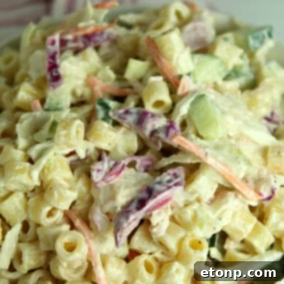 Coleslaw Pasta Salad in a bowl with serving utensils