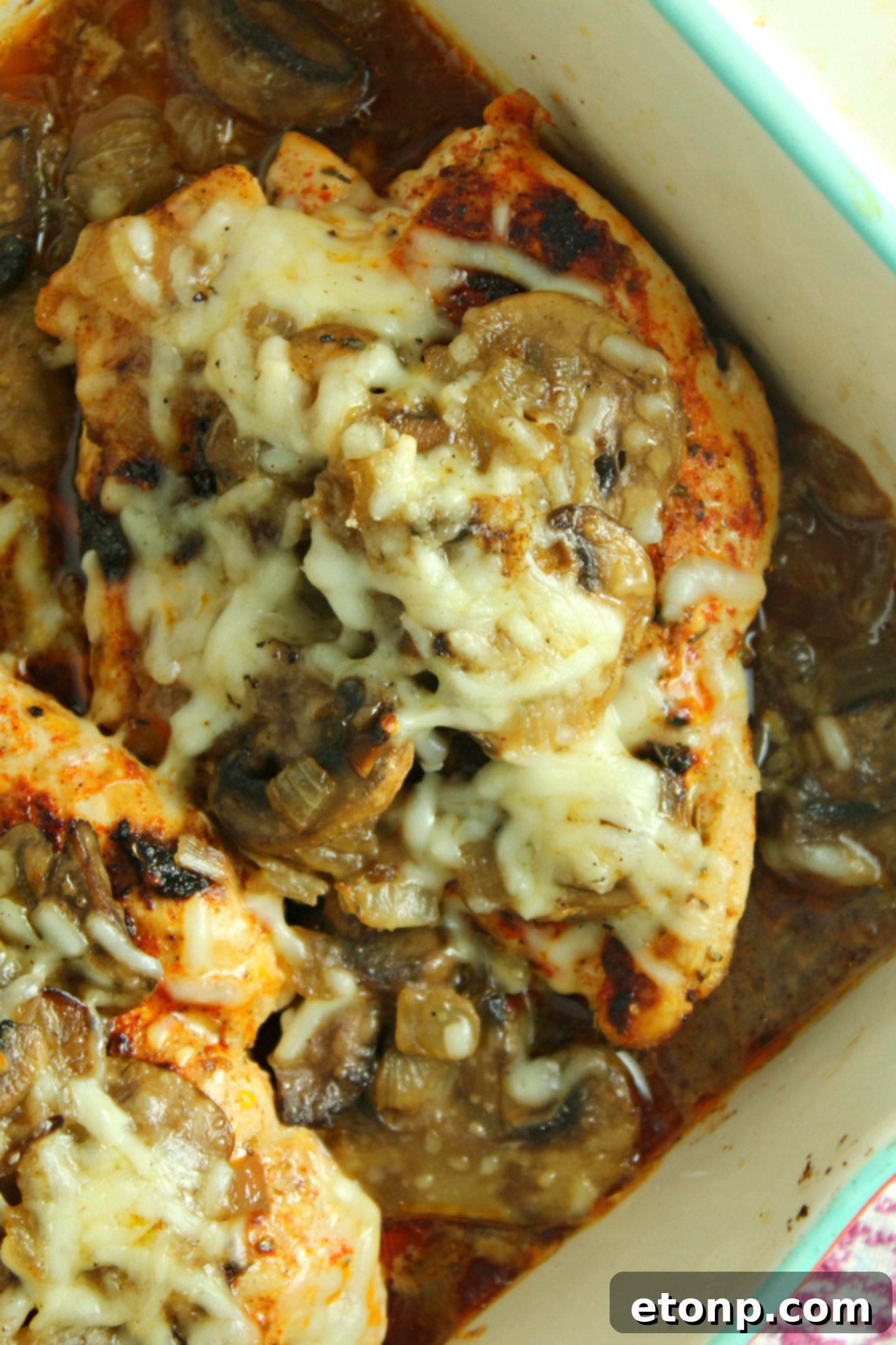 The final presentation of Smothered Cheesy Baked Chicken with Mushrooms, capturing its rich and inviting appearance.