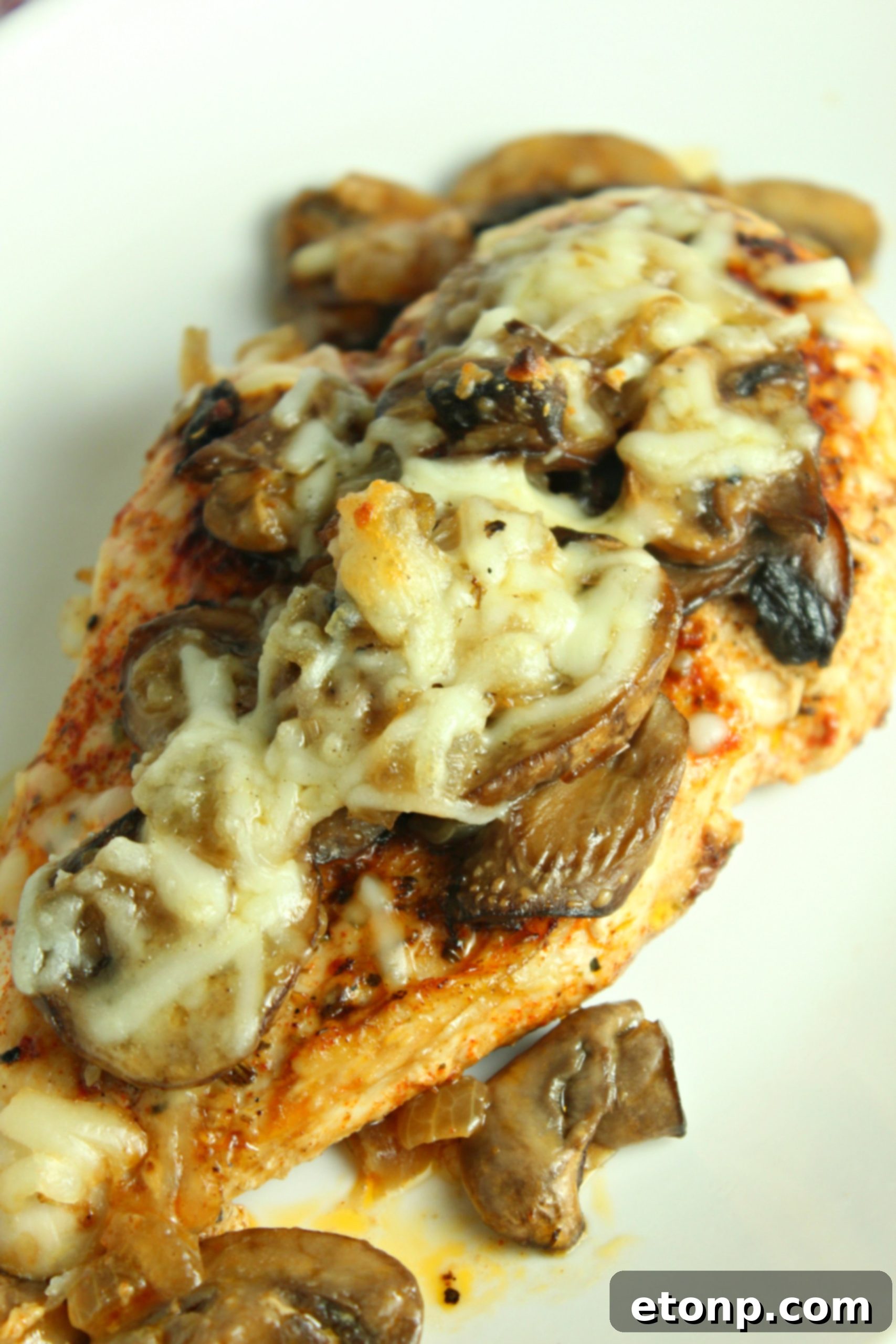 The finished Smothered Cheesy Baked Chicken dish, served with a fresh green salad, emphasizing a balanced meal.