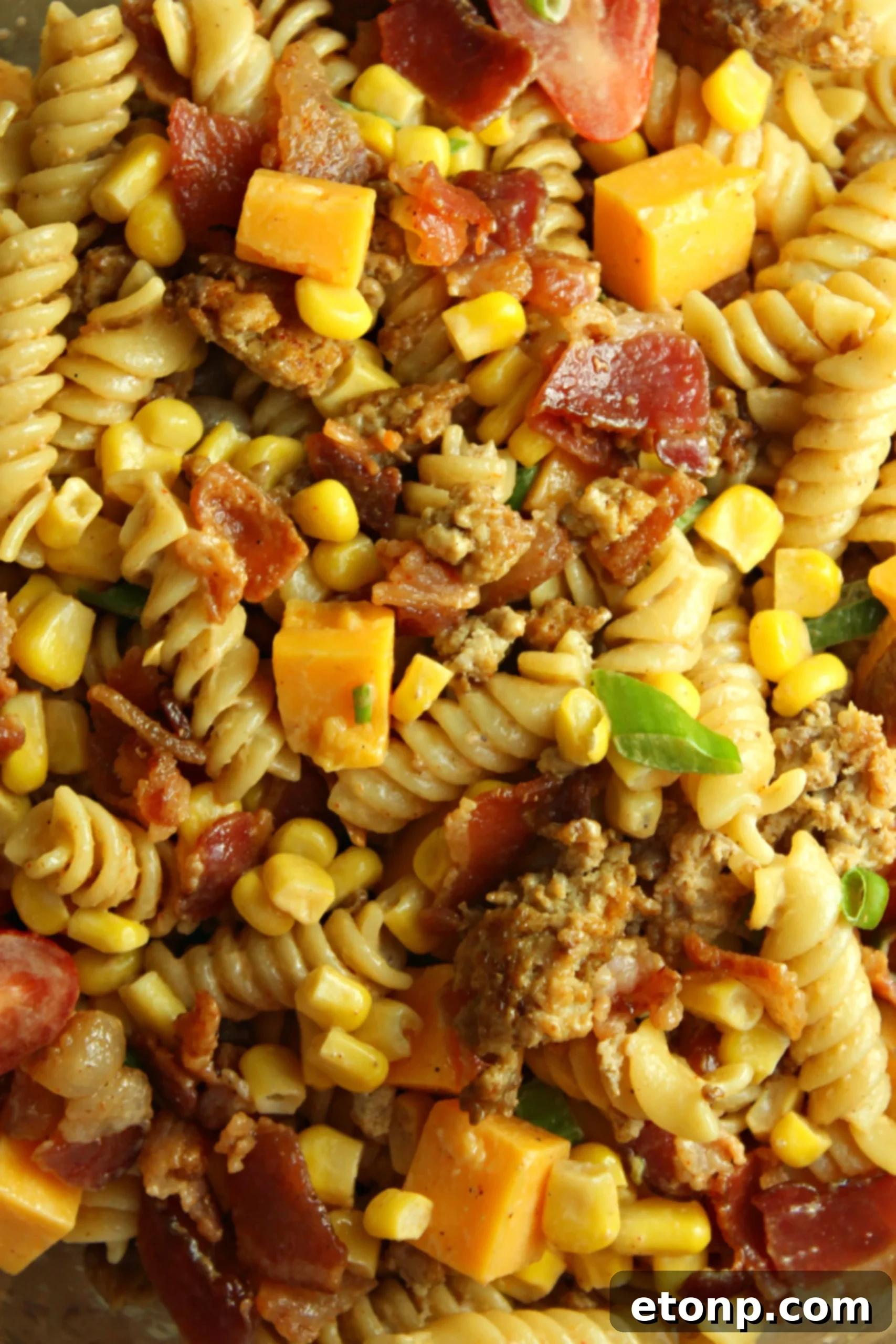 Chuckwagon Pasta Salad 7 Loaded Cowboy Pasta Salad served in a rustic bowl on a wooden surface, highlighting its appealing presentation.