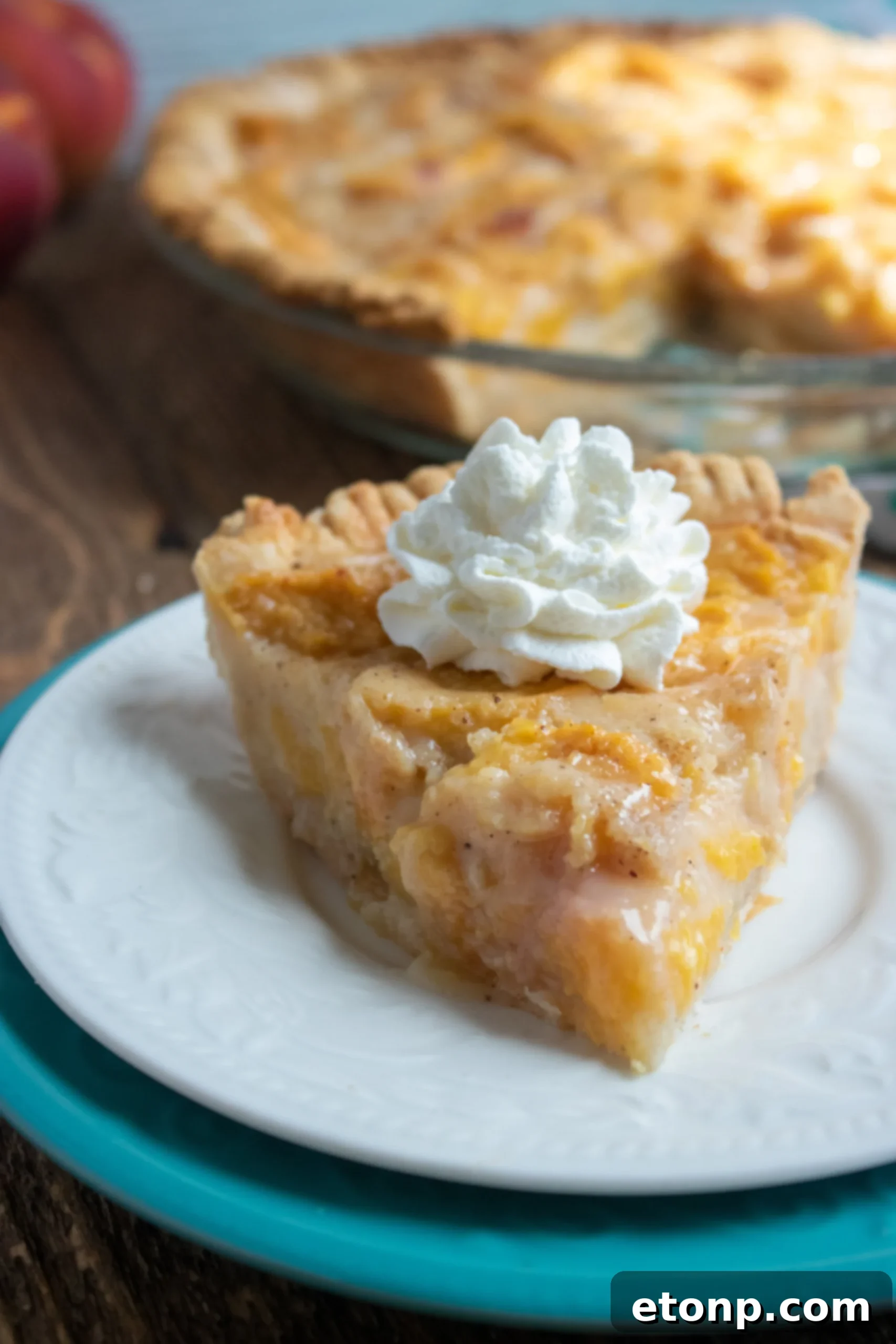 Close-up of a generous slice of Southern Peach Pie, showing its delicious layers