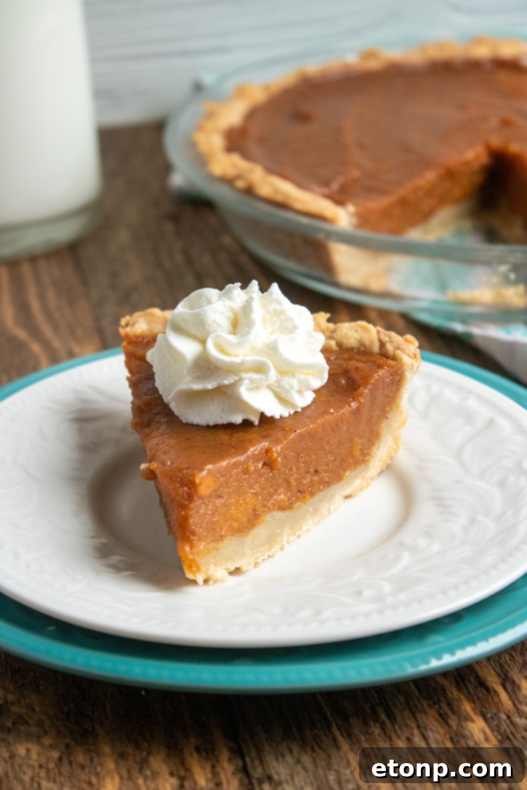 Close-up shot of a sweet potato pie slice, showcasing its creamy texture and the golden, flaky crust.