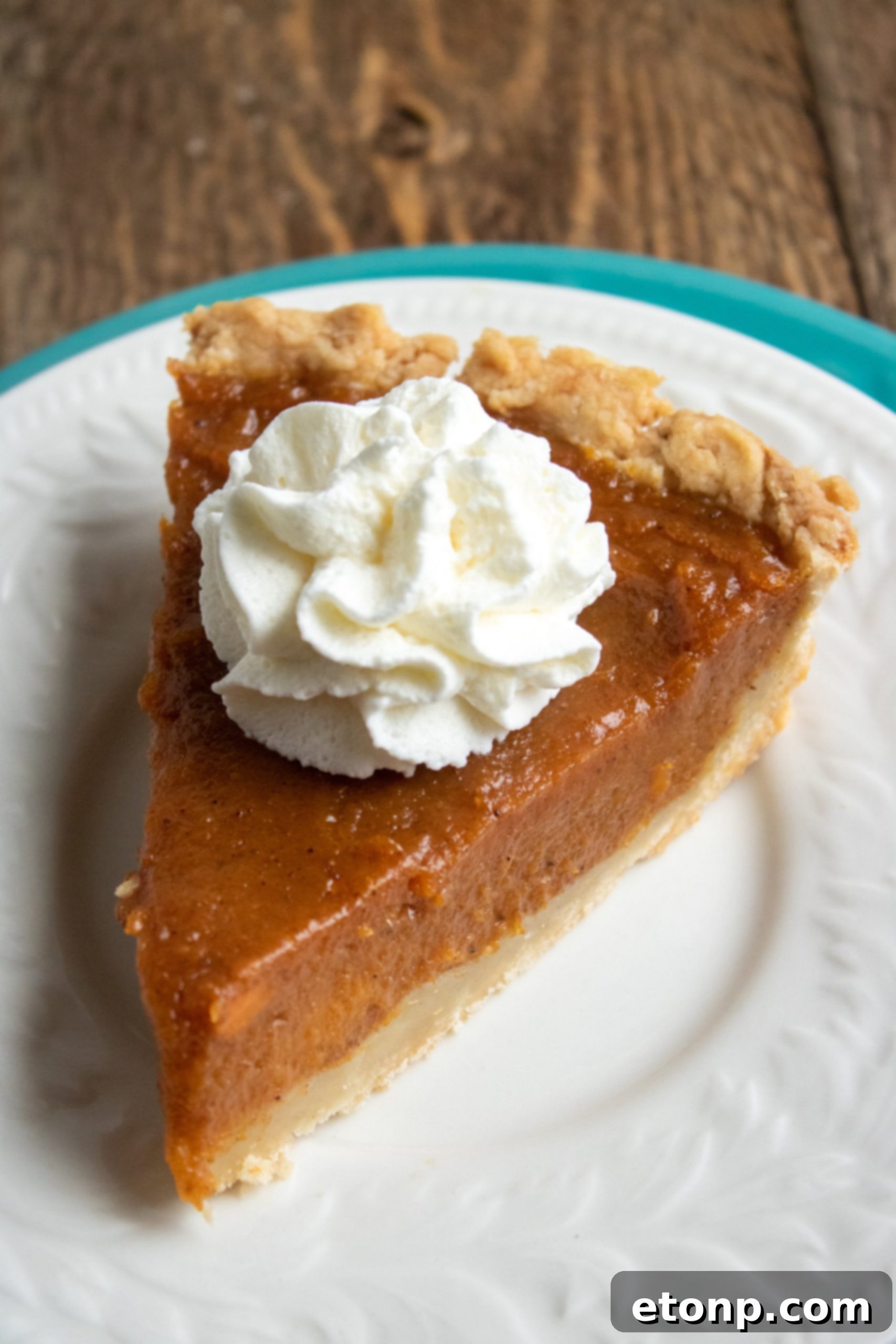 A rustic, wholesome sweet potato pie, presented simply on a wooden surface.