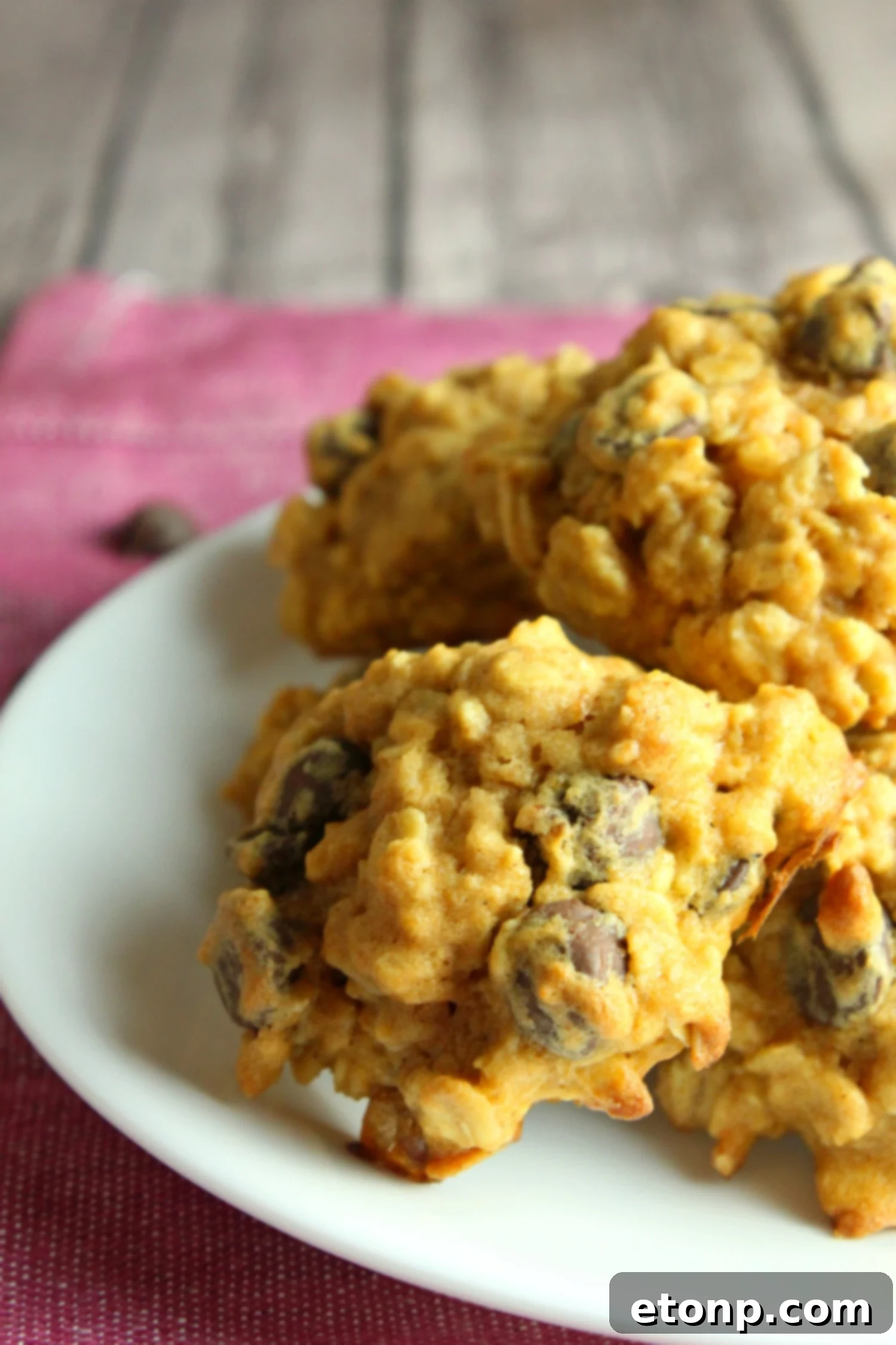 Stack of Pumpkin Oatmeal Chocolate Chip Cookies on a cooling rack