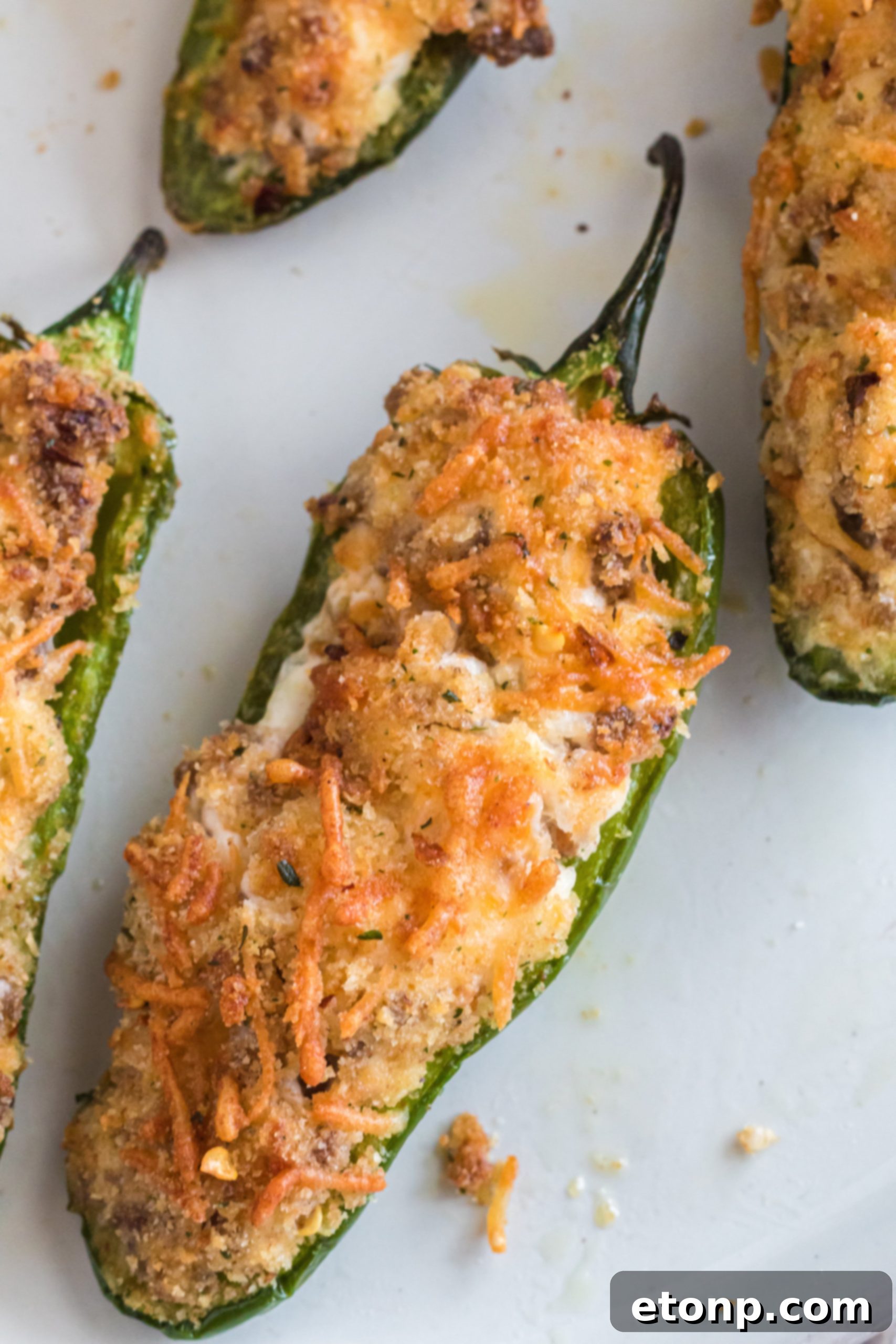 Close-up of golden brown Air Fryer Jalapeno Poppers, perfectly cooked and ready to serve.