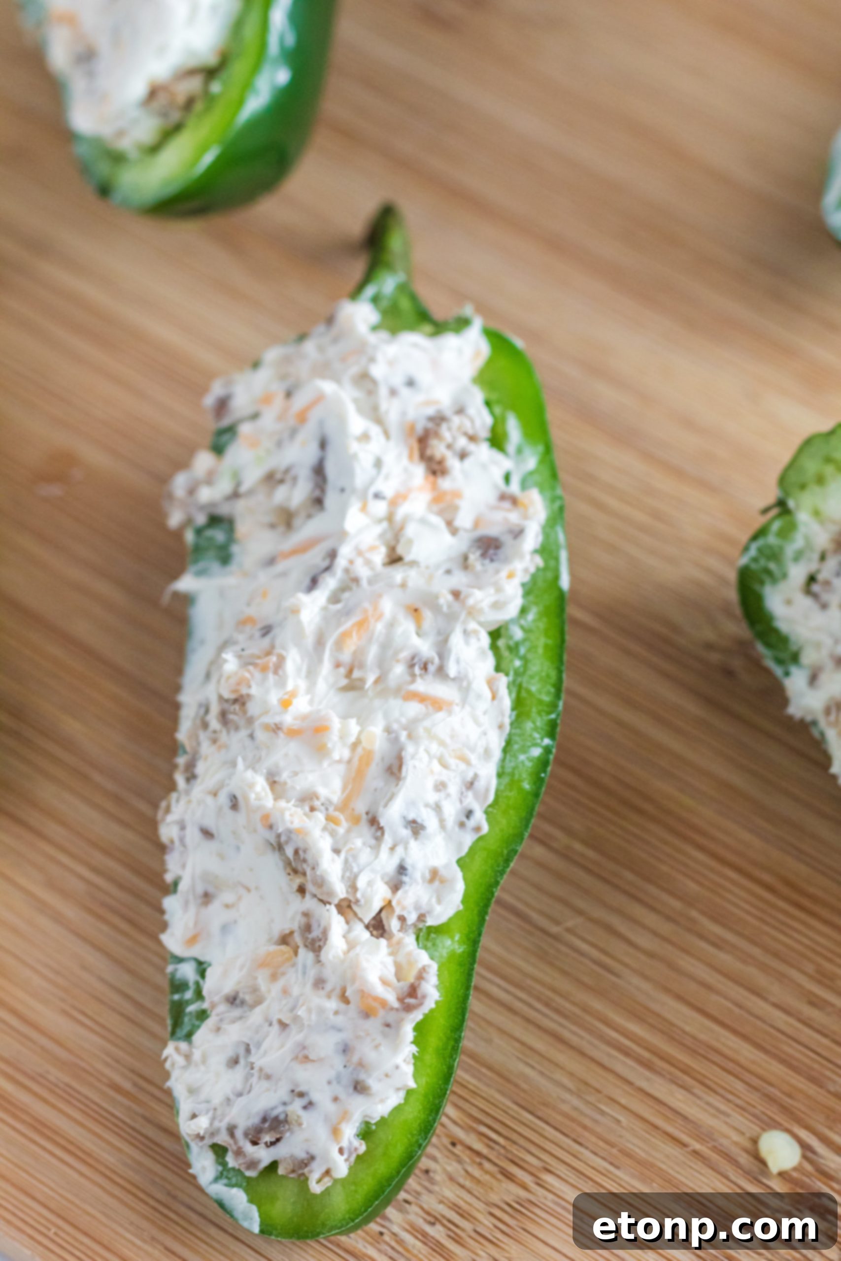 A plate of freshly prepared Air Fryer Jalapeno Poppers, showcasing their delicious filling and crisp exterior.