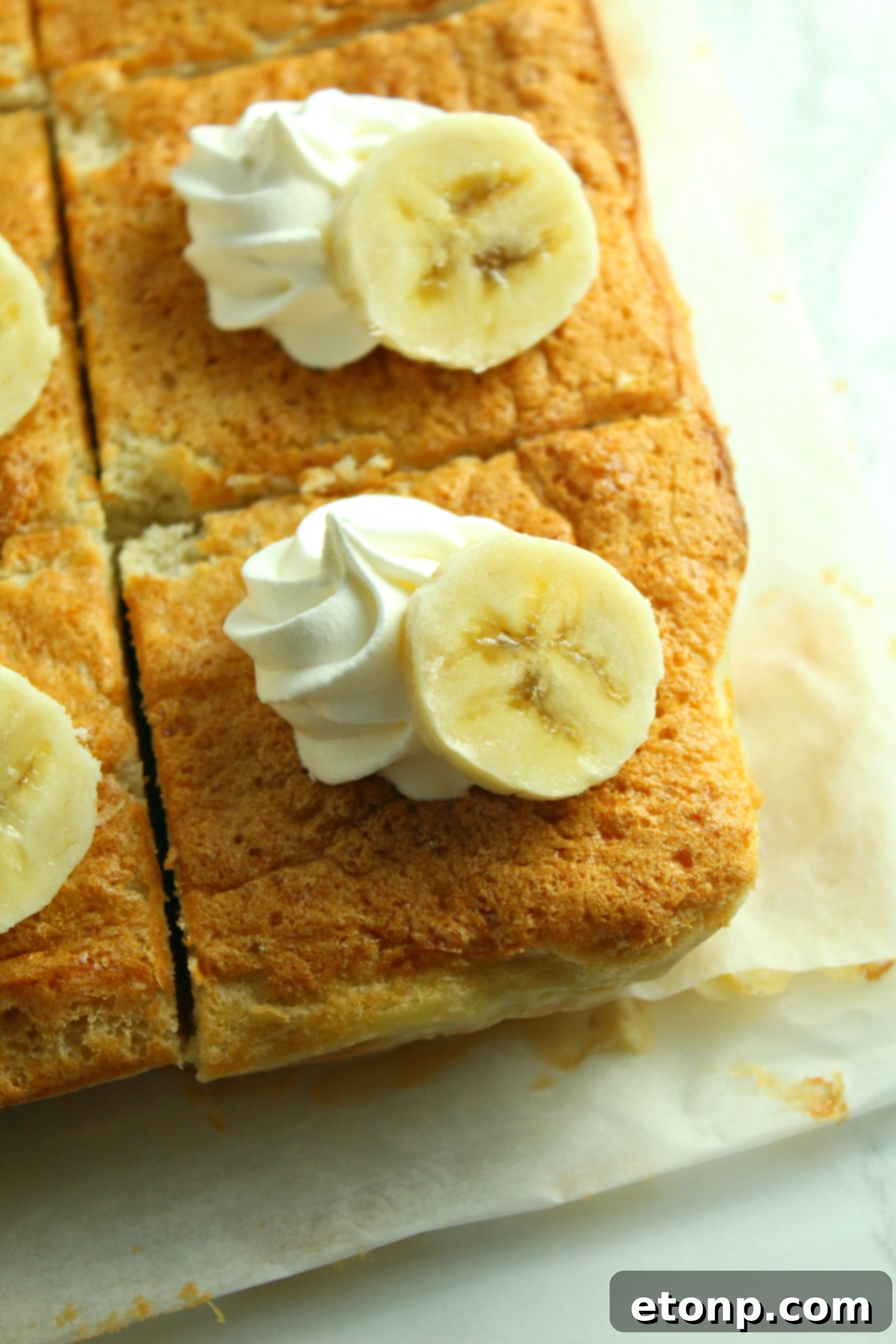 Another perspective of the Banana Magic Cake, showcasing its delightful golden crust and moist appearance, ready to be sliced.