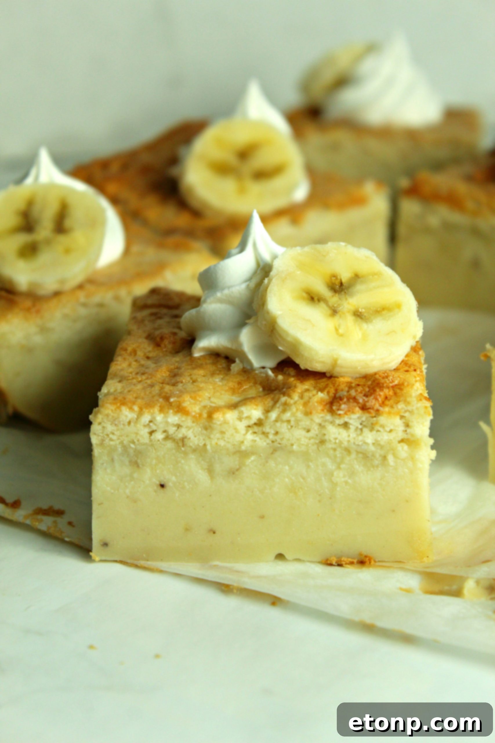 A whole Banana Magic Cake, freshly baked and cooled, ready for slicing and serving.