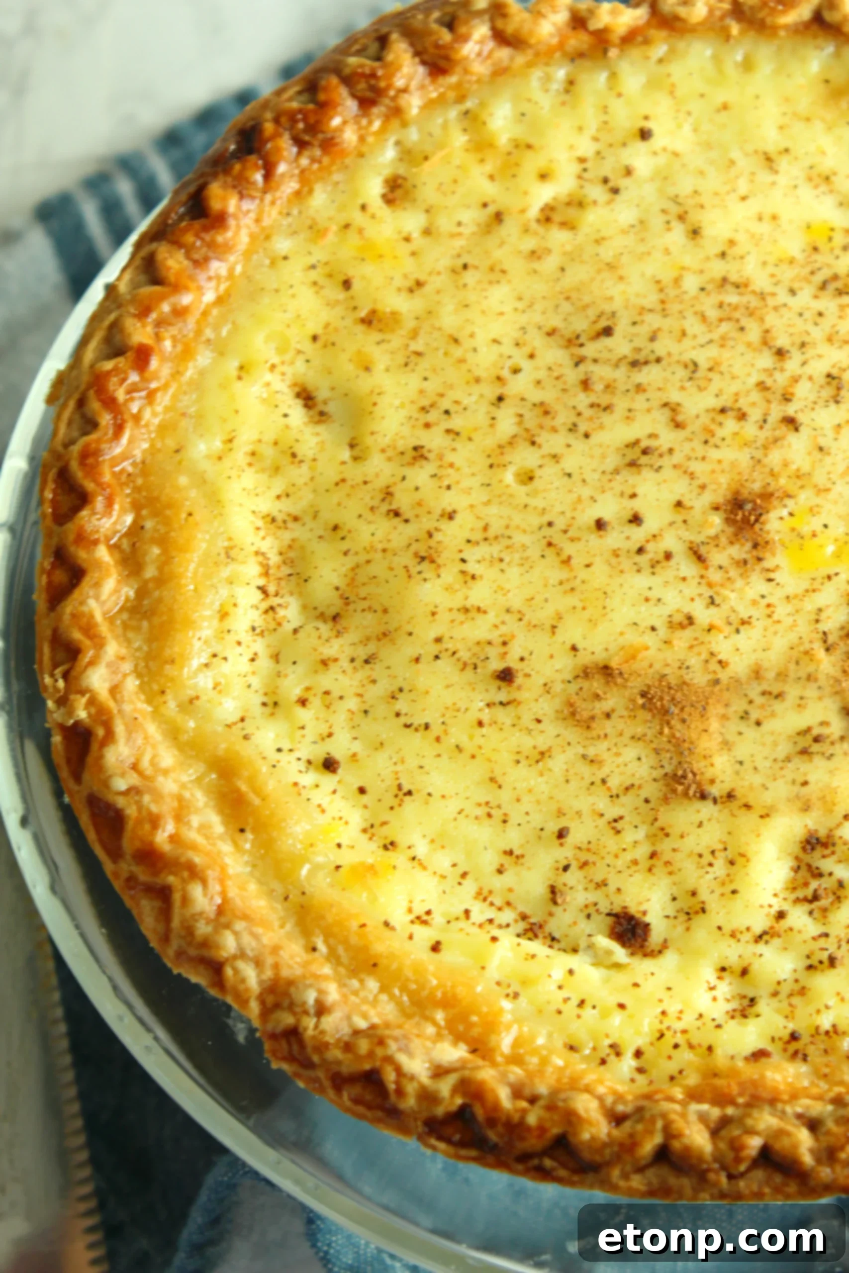 A top-down view of the whole custard pie, showcasing its perfect golden crust.
