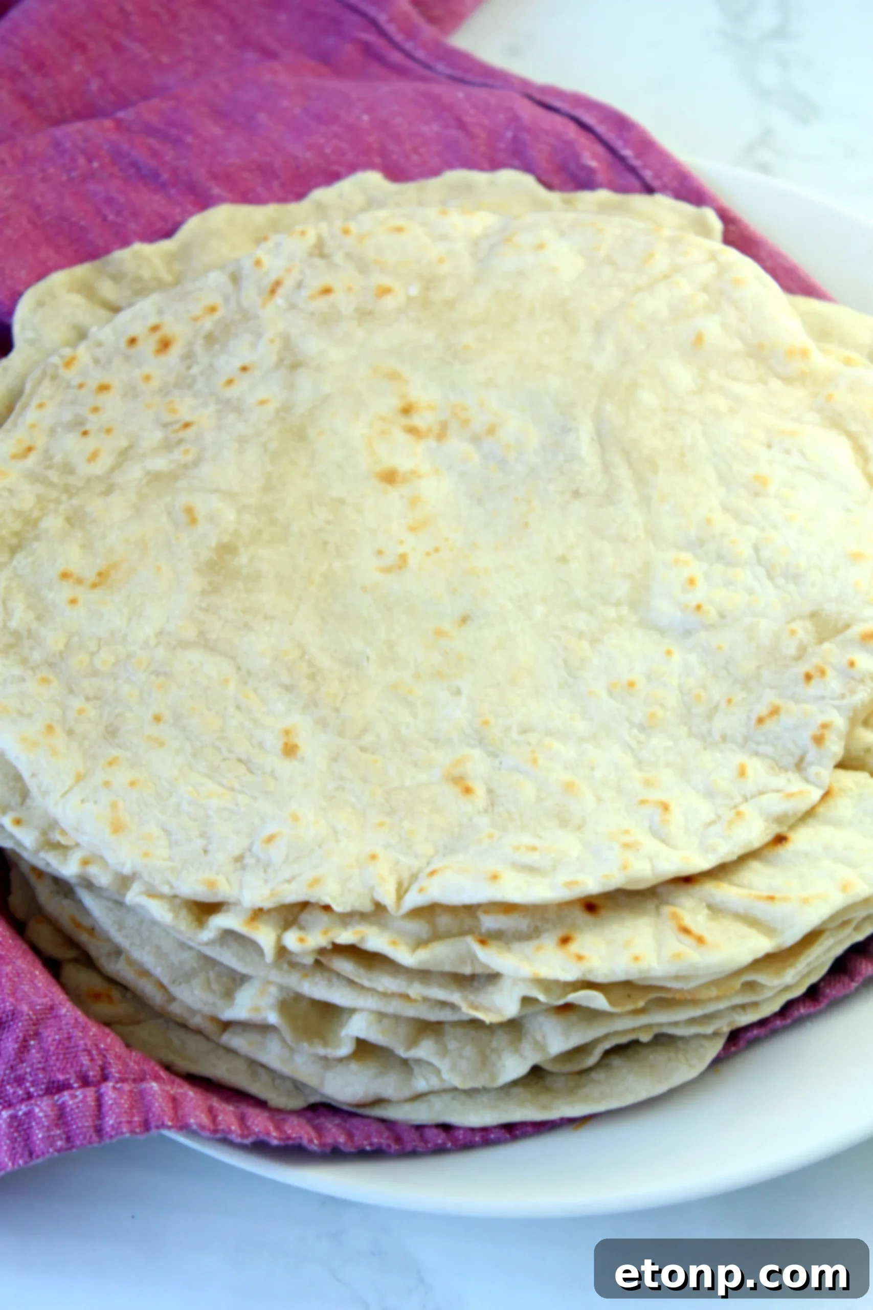 A selection of homemade flour tortillas ready for various Mexican dishes.
