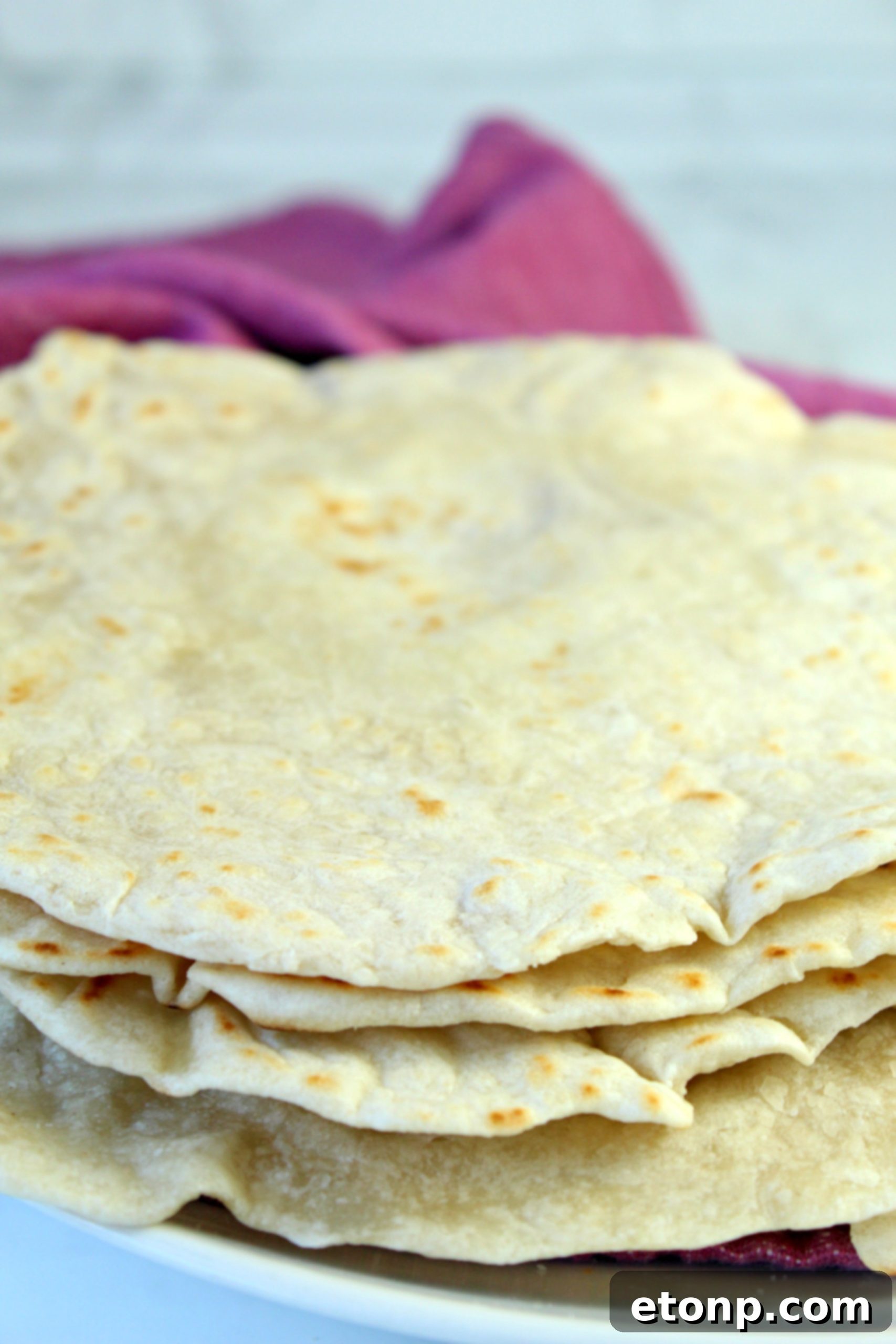 Portioned dough balls for homemade flour tortillas, arranged on a surface.