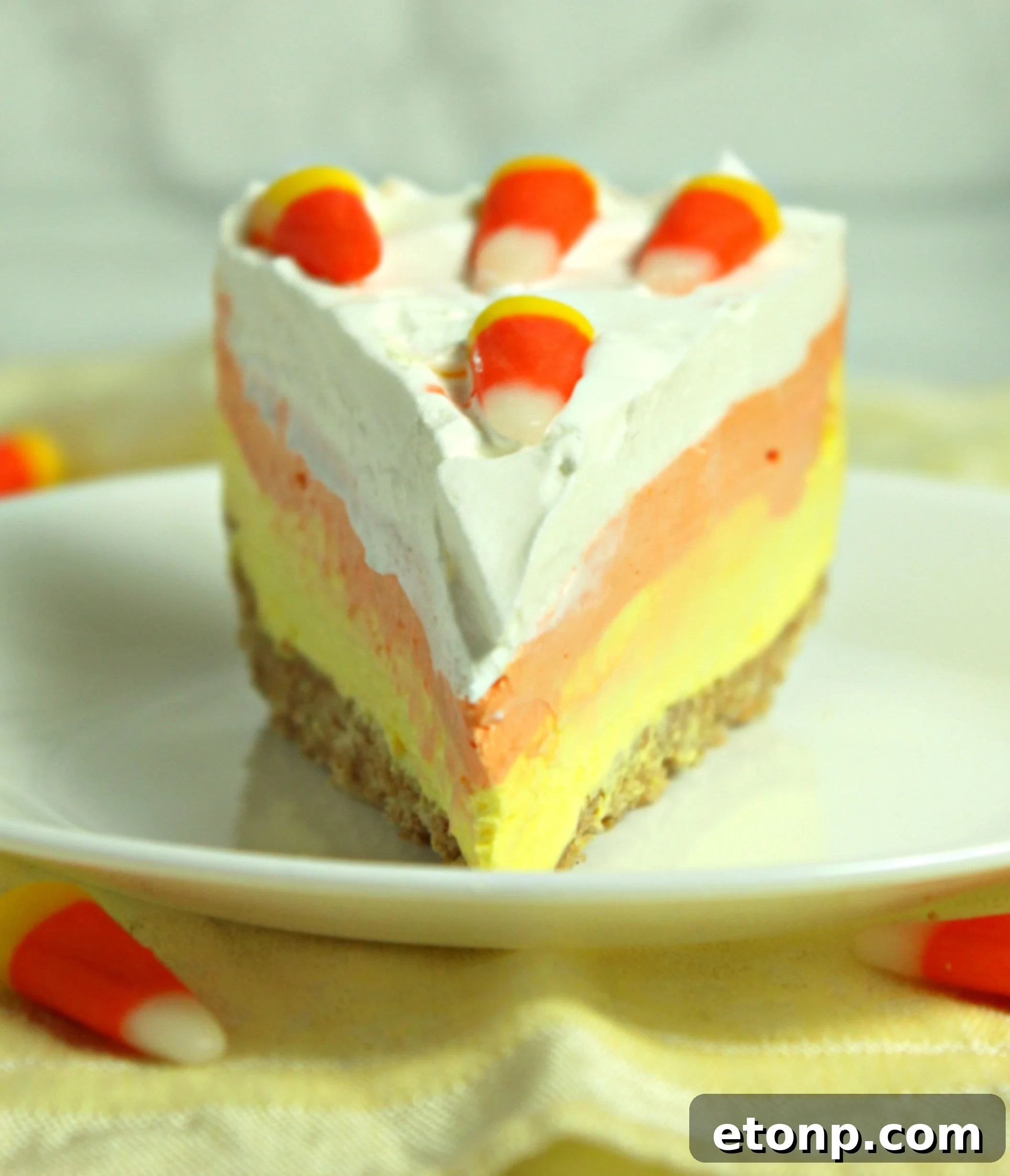 Another enticing view of the No-Bake Candy Corn Cheesecake, emphasizing its smooth and creamy layers.