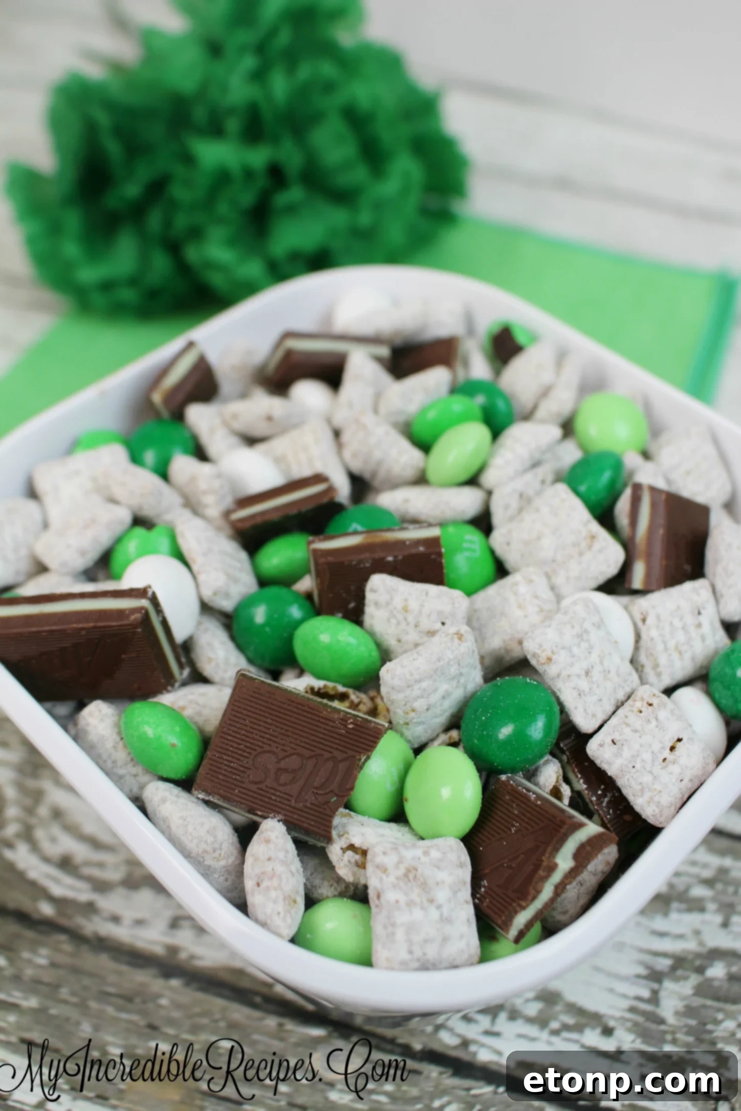 A close-up of Andes Mint Muddy Buddies in a serving bowl, showcasing the individual pieces and their delicious coating.